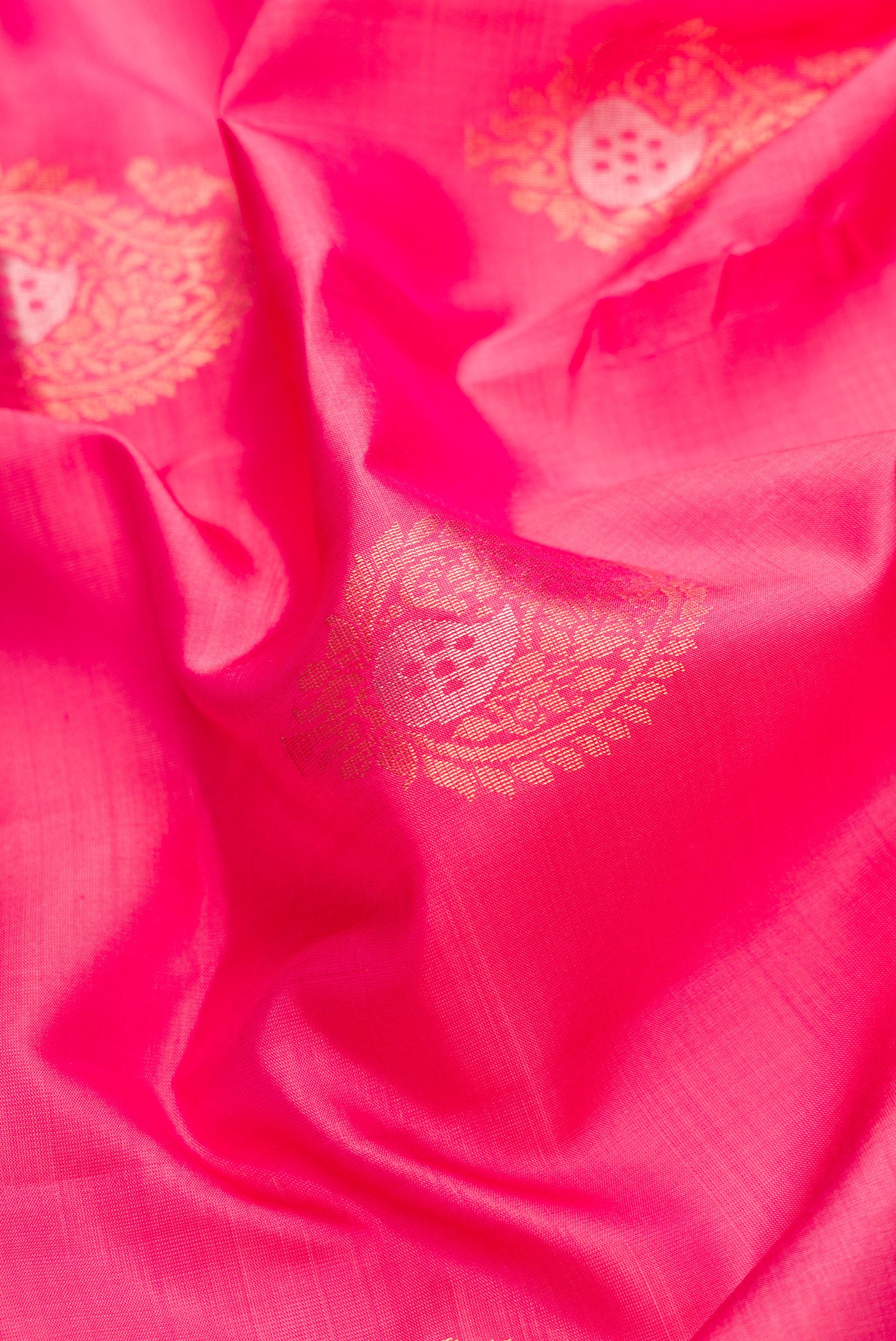 Close up of Pink Dual Tone Soft Silk Saree with Zari Butta on the body and Zari Border.  displaying folds