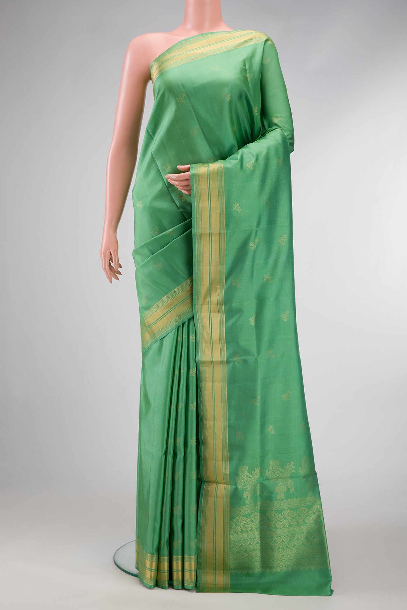 Pista Green Dual Tone Soft Silk Saree with Zari Butta on the body and Zari Border.  displayed on a mannequin