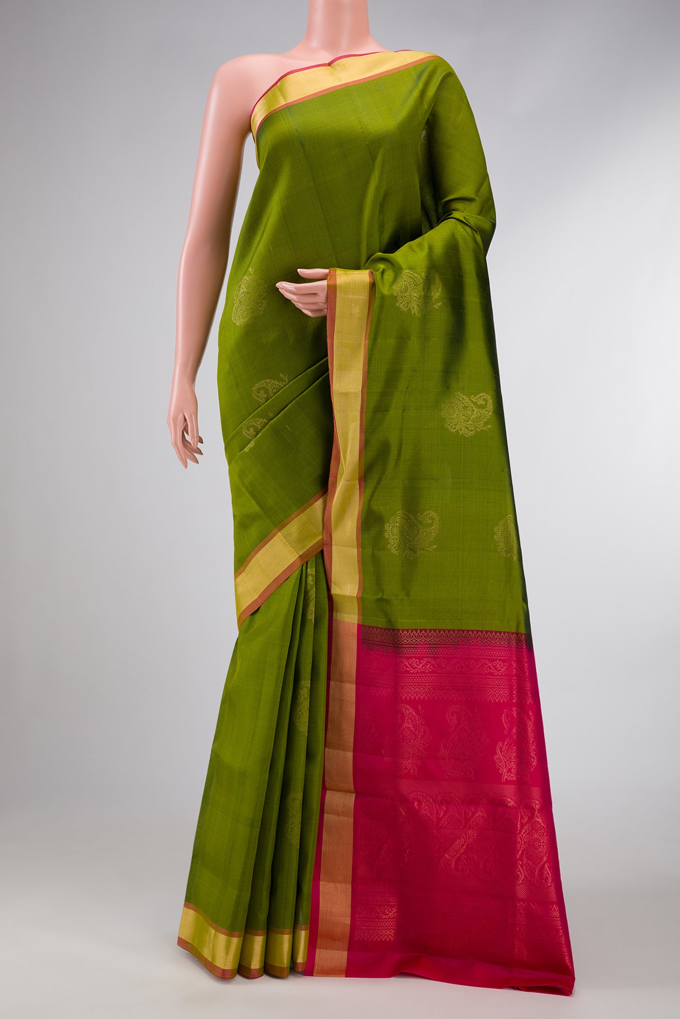 Green Dual Tone Soft Silk Saree with Zari Butta on the body and Zari Border.  displayed on a mannequin