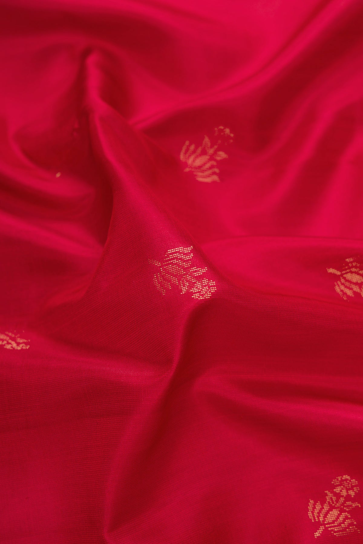 Close up of Maroon Dual Tone Soft Silk Saree with Zari Butta on the body and Zari Border.  displaying folds