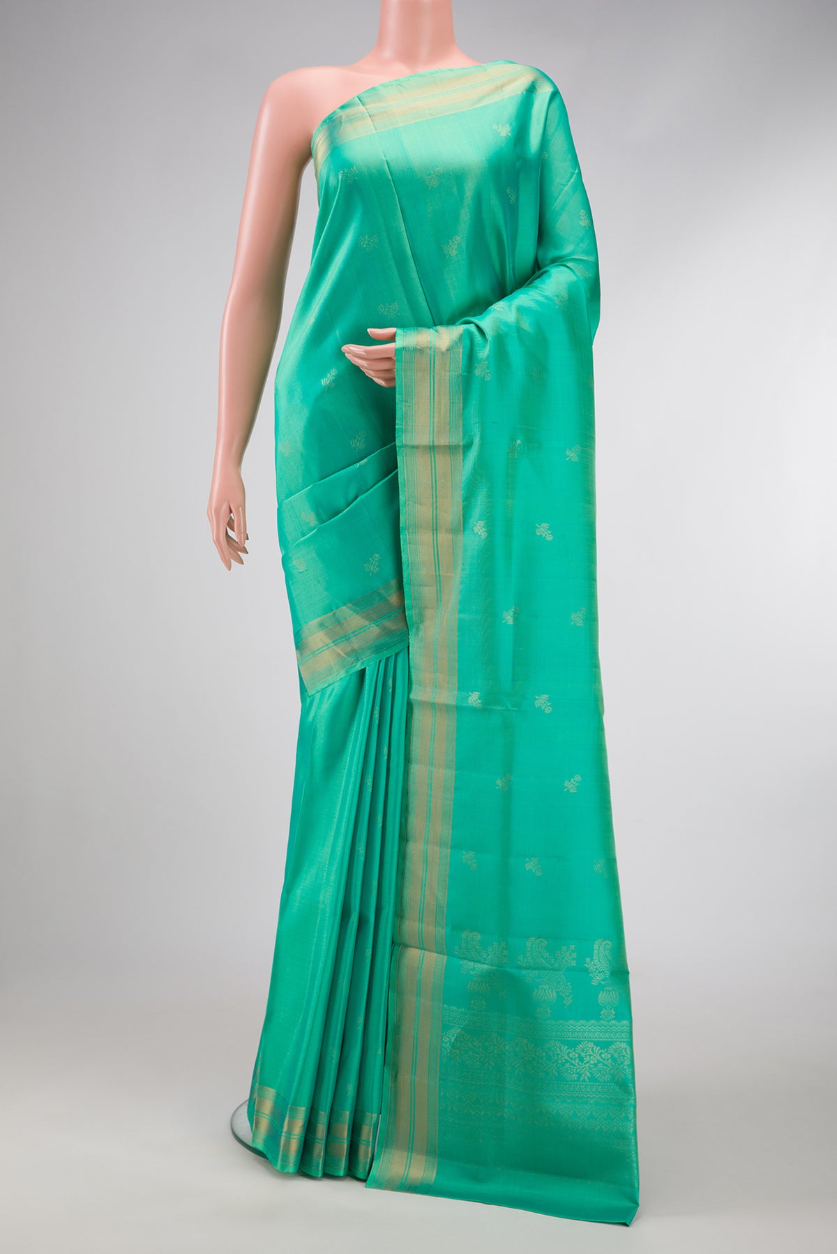 Sea Green Dual Tone Soft Silk Saree with Zari Butta on the body and Zari Border.  displayed on a mannequin