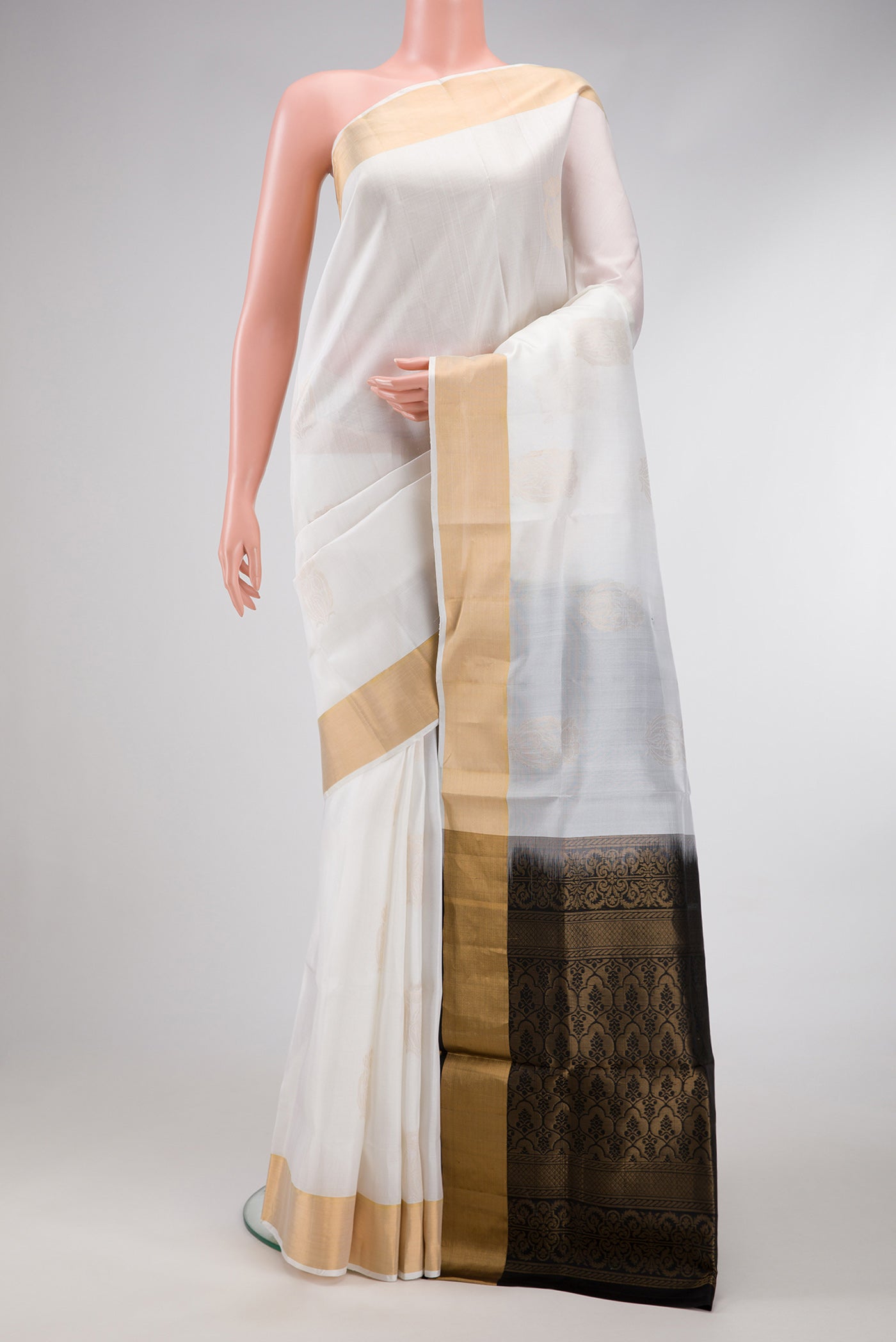 Off White Dual Tone Soft Silk Saree with Zari Butta on the body and Zari Border.  displayed on a mannequin