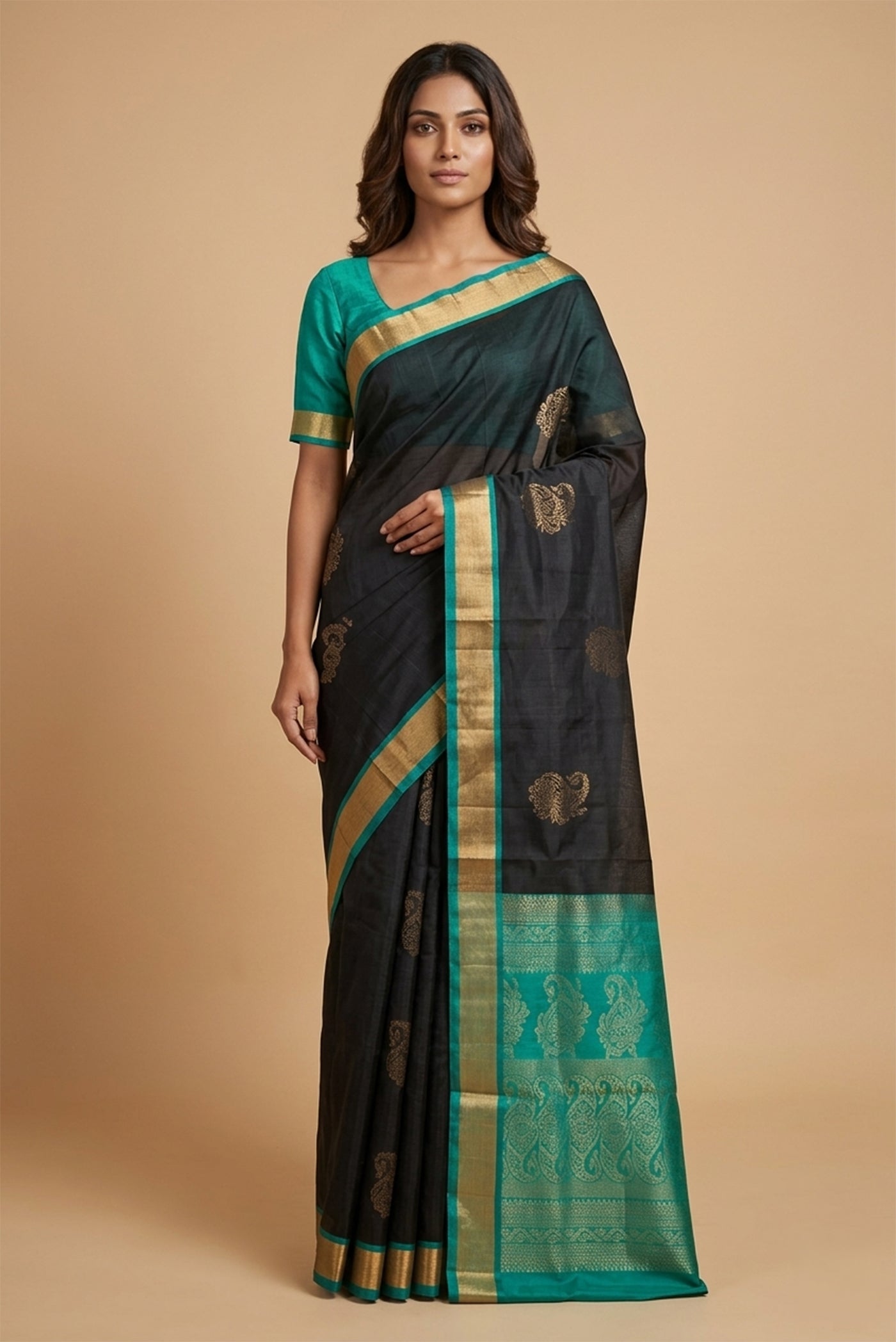 Model wearing a Black Soft Silk Saree with Zari Butta on the body and Zari Border.