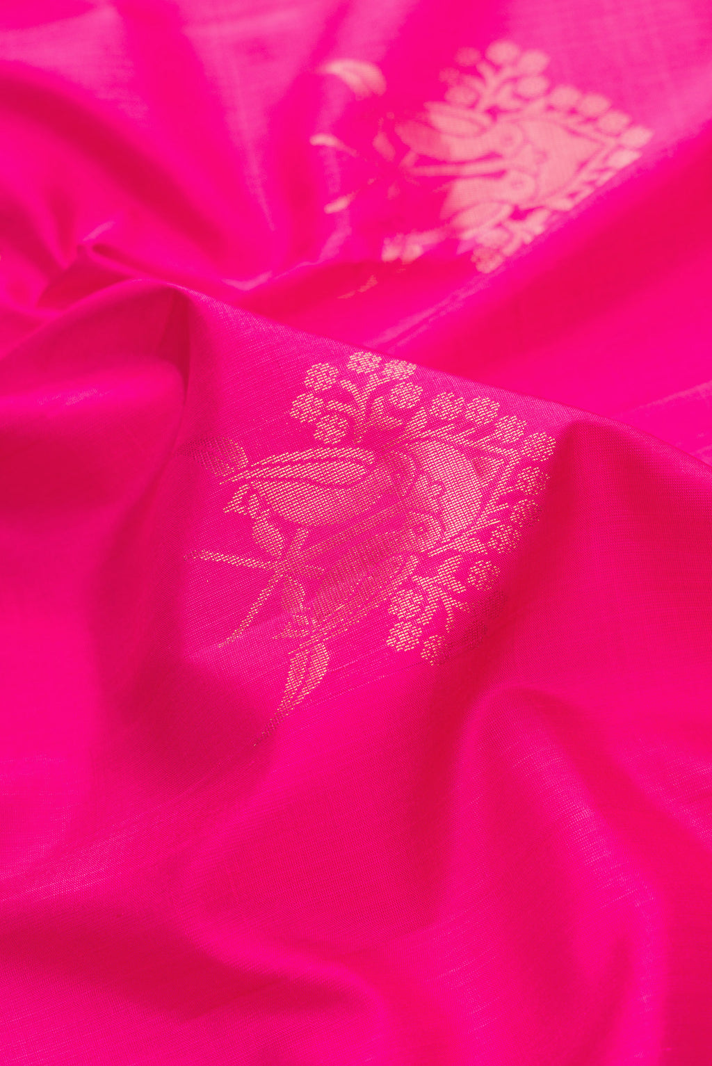 Close up of Pink Dual Tone Soft Silk Saree with Zari Butta on the body and Zari Border.  displaying folds