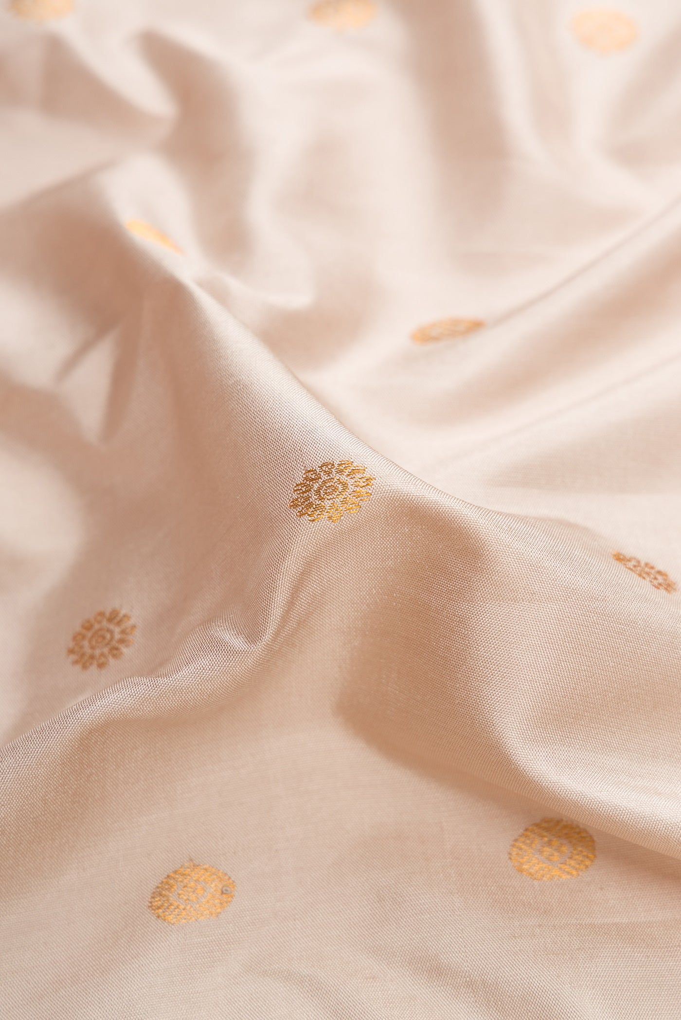Close up of Dark Beige Dual Tone Gadwal Silk Saree with Zari Butta on the body and Zari Border.  displaying folds