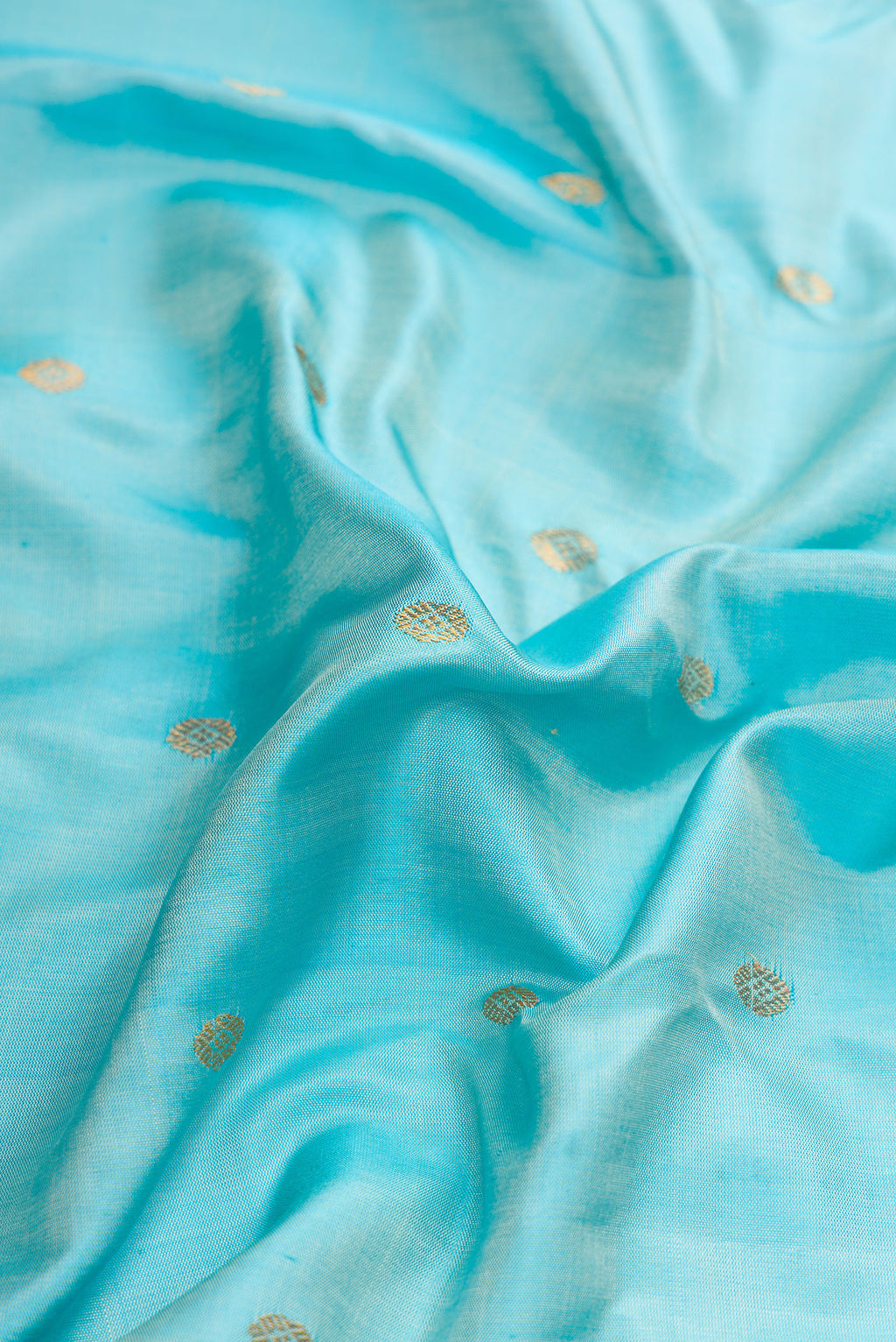 Close up of Sky Blue Dual Tone Gadwal Silk Saree with Zari Butta on the body and Zari Border.  displaying folds