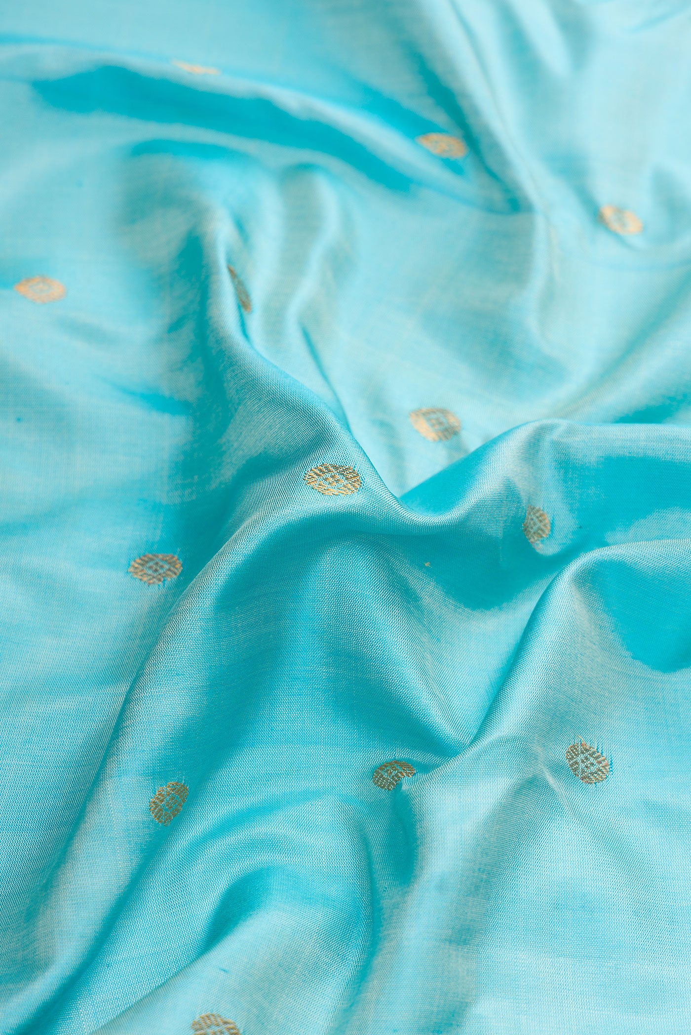 Close up of Sky Blue Dual Tone Gadwal Silk Saree with Zari Butta on the body and Zari Border.  displaying folds