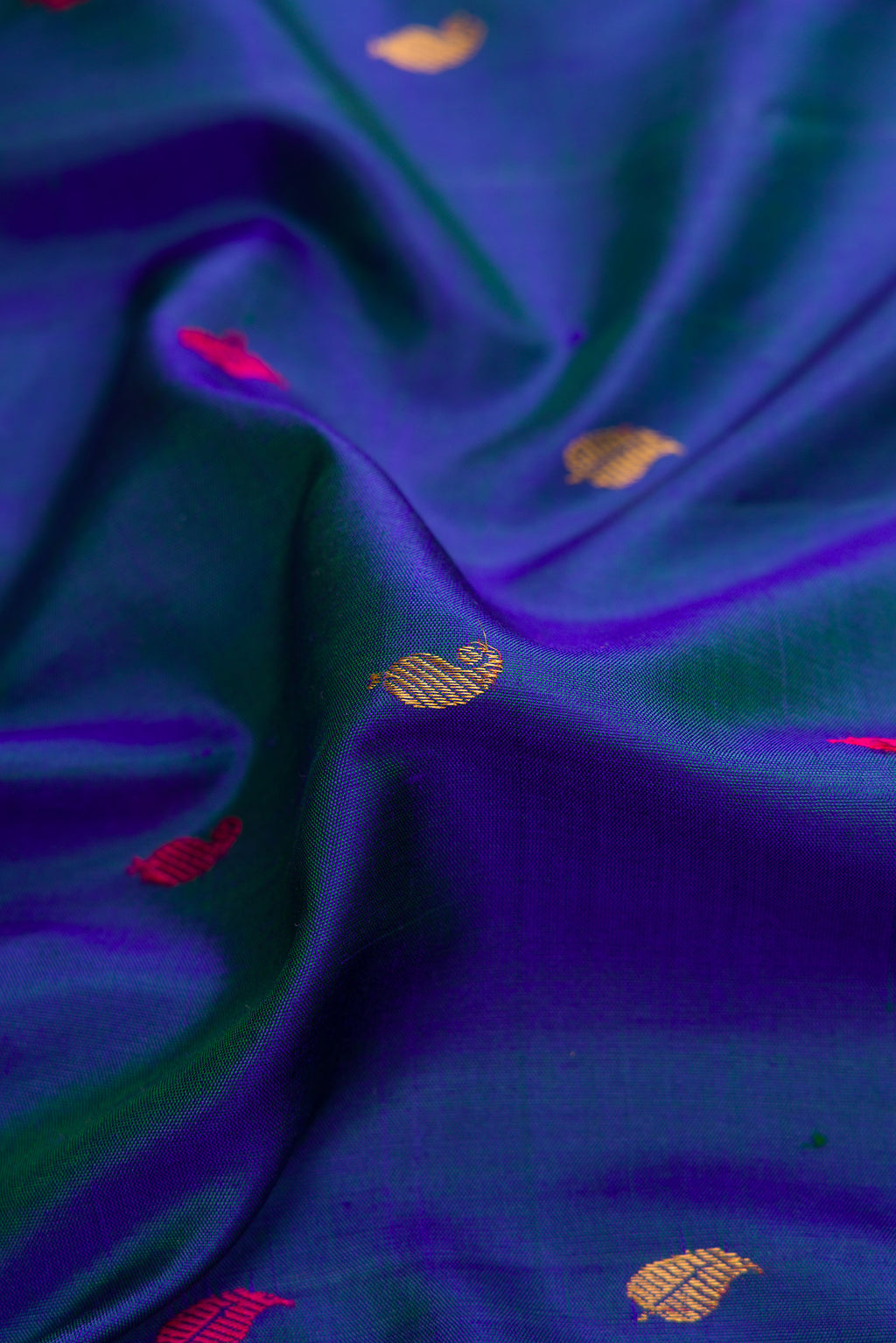 Close up of Peacock Blue Dual Tone Gadwal Silk Saree with Zari And Thread Butta on the body and Zari Border.  displaying folds
