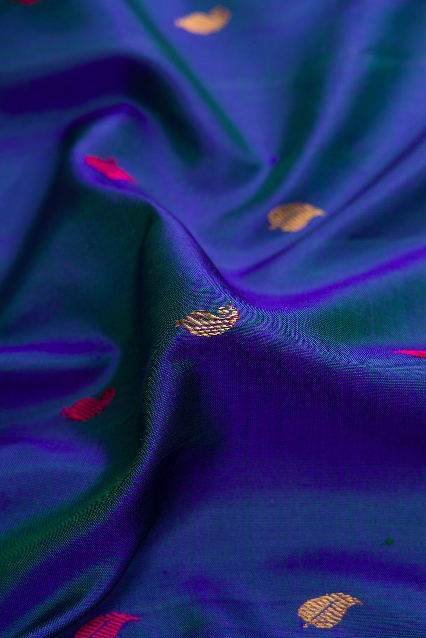 Close up of Peacock Blue Dual Tone Gadwal Silk Saree with Zari And Thread Butta on the body and Zari Border.  displaying folds