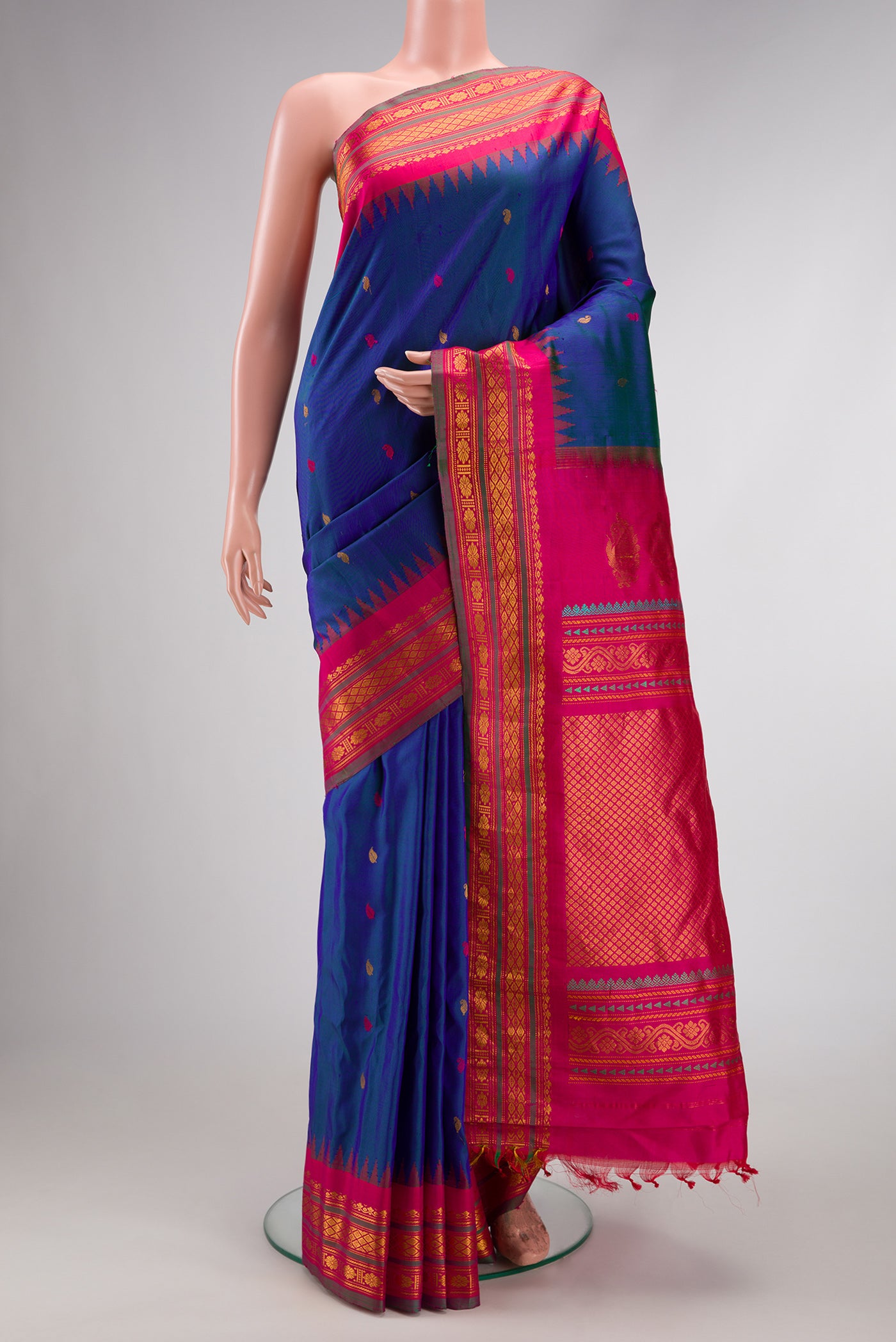 Peacock Blue Dual Tone Gadwal Silk Saree with Zari And Thread Butta on the body and Zari Border.  displayed on a mannequin