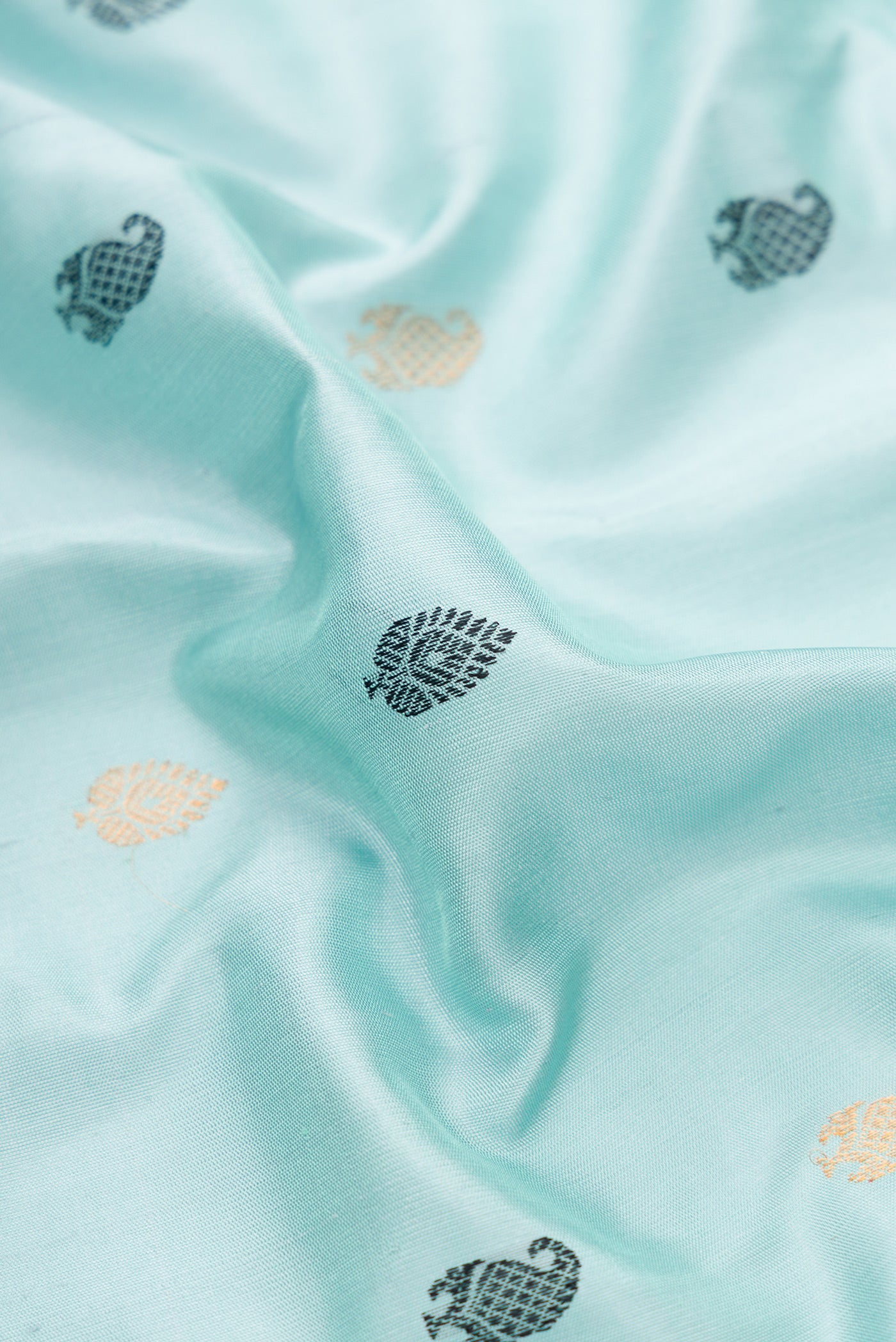 Close up of Light Blue Dual Tone Gadwal Silk Saree with Zari And Thread Butta on the body and Temple Border.  displaying folds