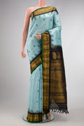 Light Blue Dual Tone Gadwal Silk Saree with Zari And Thread Butta on the body and Temple Border.  displayed on a mannequin