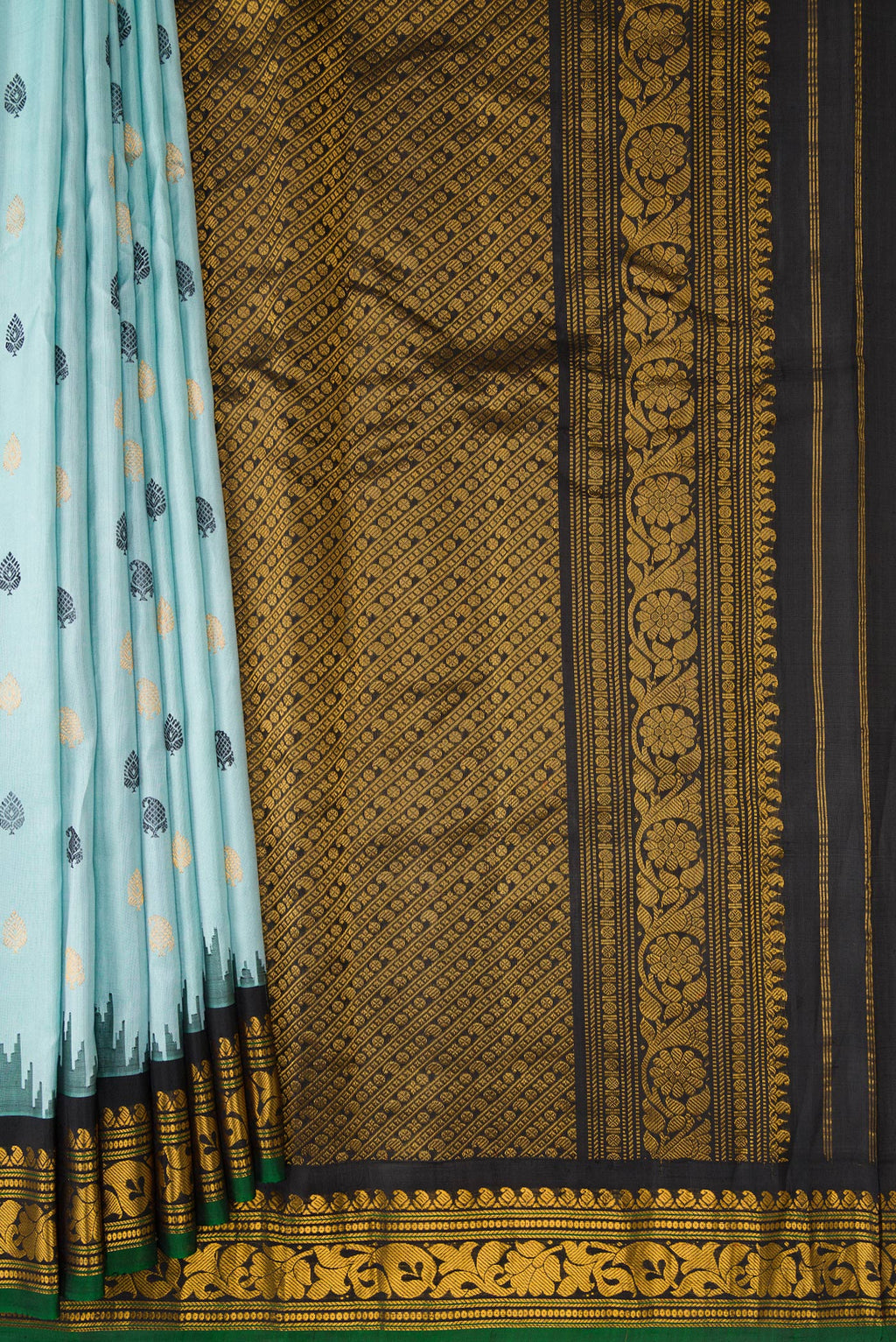 Pleats and pallu of Light Blue Dual Tone Gadwal Silk Saree with Zari And Thread Butta on the body and Temple Border. 