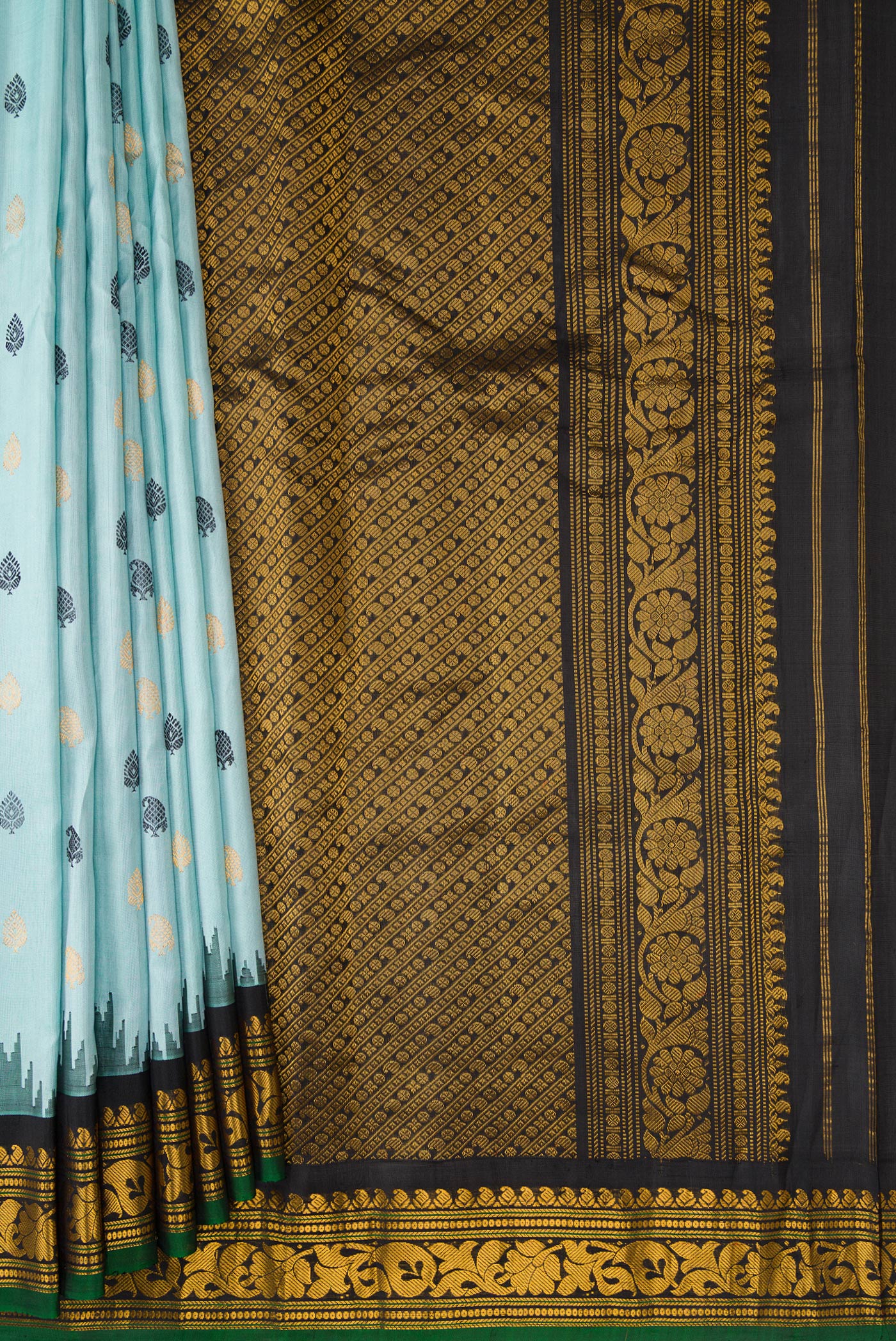 Pleats and pallu of Light Blue Dual Tone Gadwal Silk Saree with Zari And Thread Butta on the body and Temple Border. 