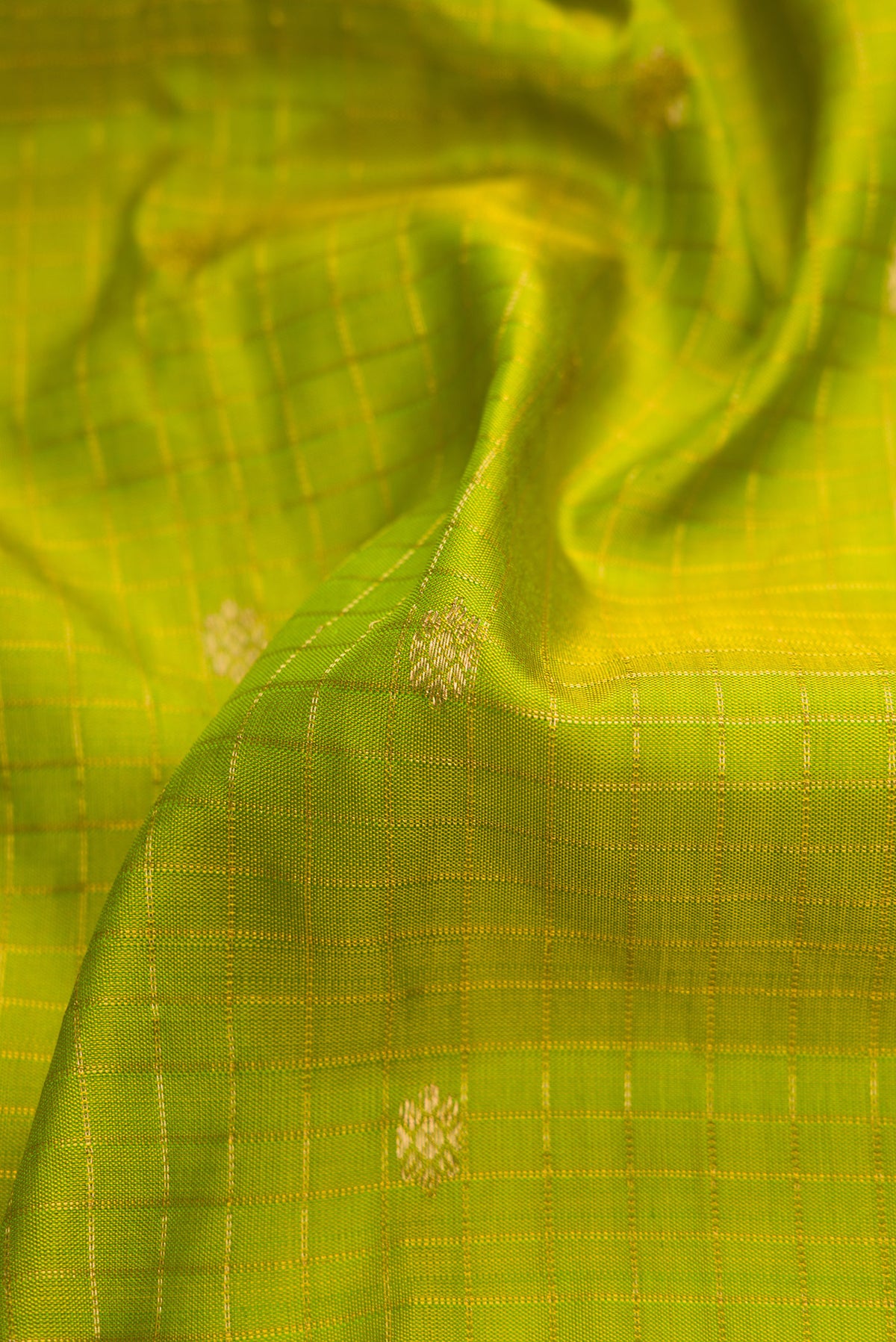 Close up of Green Dual Tone Gadwal Silk Saree with Zari Butta on the body and Zari Border.  displaying folds