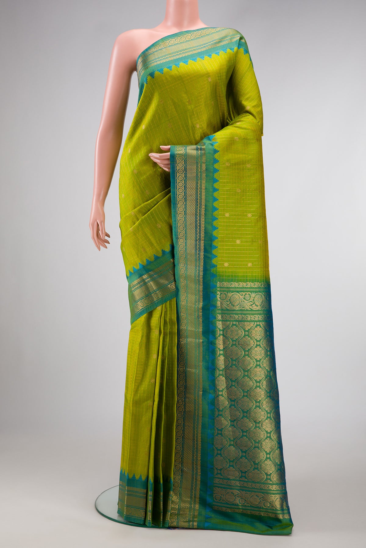 Green Dual Tone Gadwal Silk Saree with Zari Butta on the body and Zari Border.  displayed on a mannequin