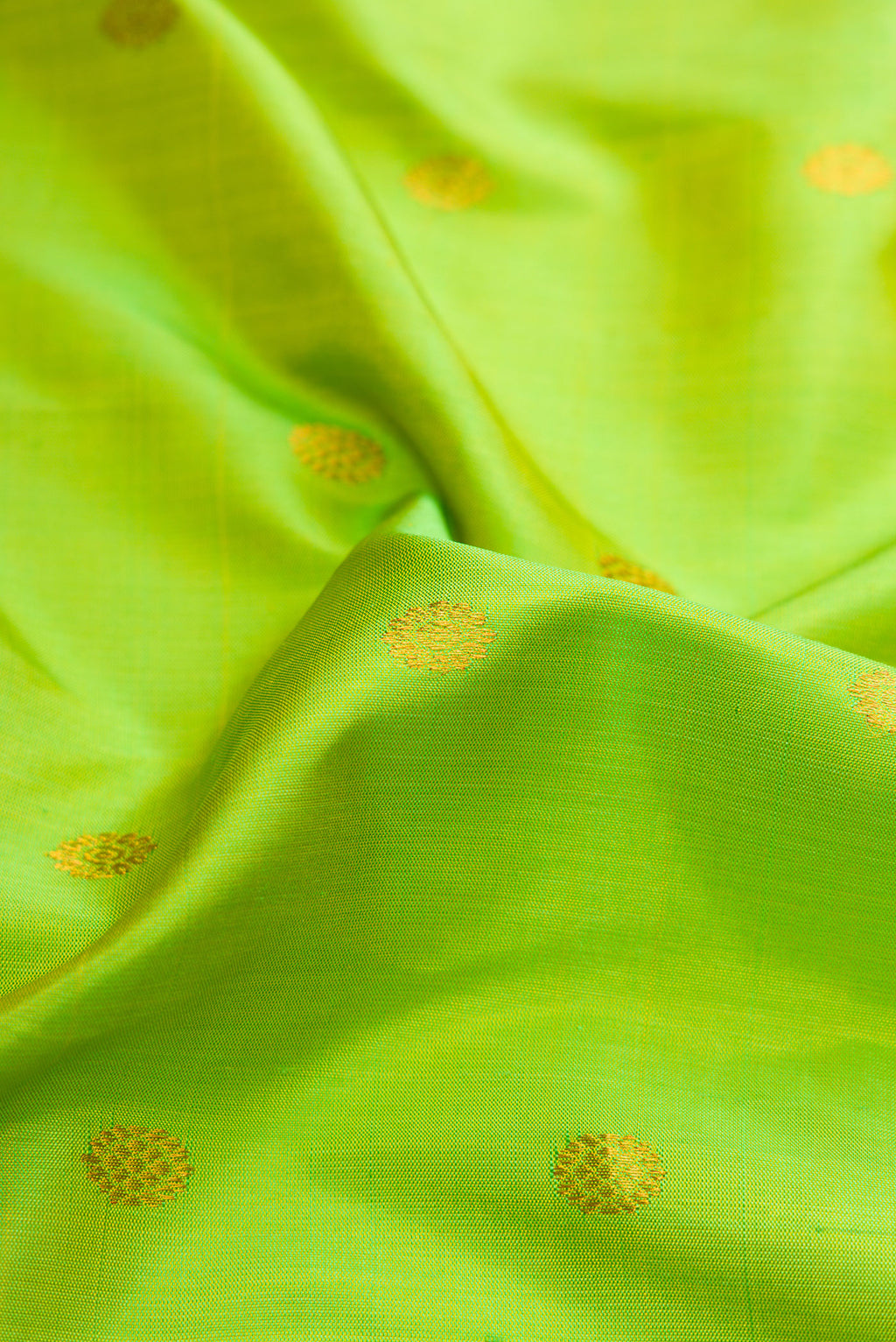 Close up of Parrot Green Dual Tone Gadwal Silk Saree with Zari Butta on the body and Zari Border.  displaying folds