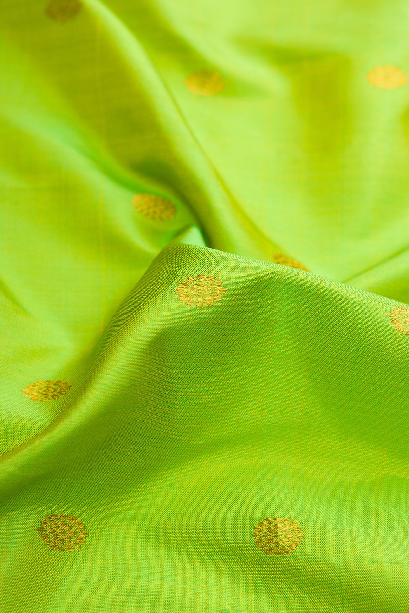 Close up of Parrot Green Dual Tone Gadwal Silk Saree with Zari Butta on the body and Zari Border.  displaying folds