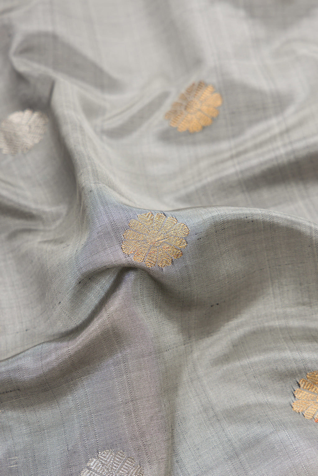 Close up of Grey Dual Tone Gadwal Silk Saree with Zari Butta on the body and Zari Border.  displaying folds