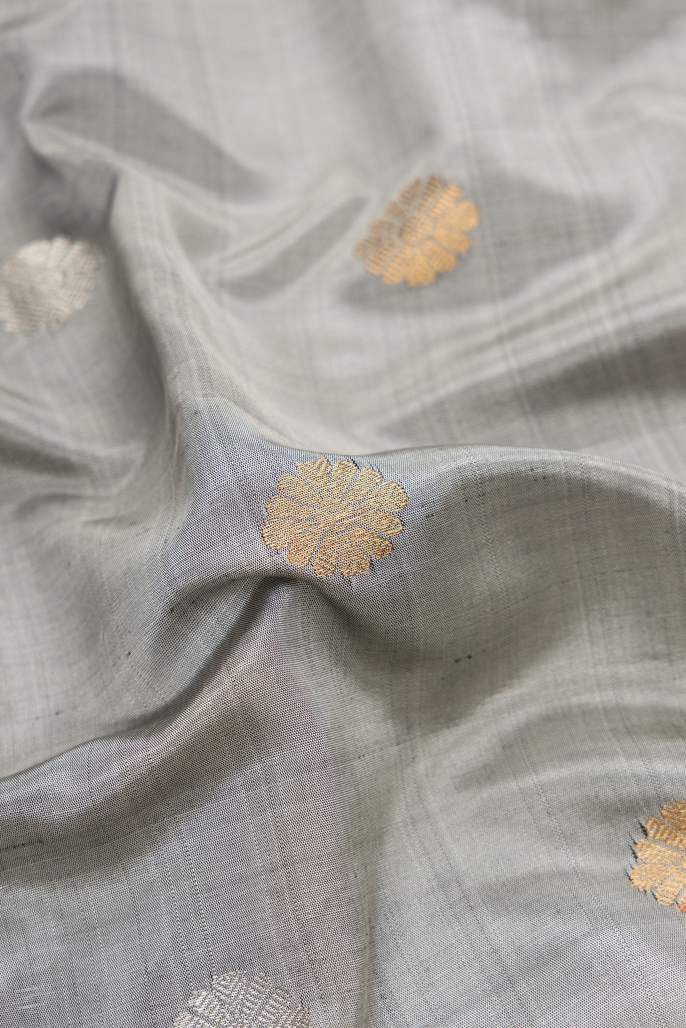 Close up of Grey Dual Tone Gadwal Silk Saree with Zari Butta on the body and Zari Border.  displaying folds