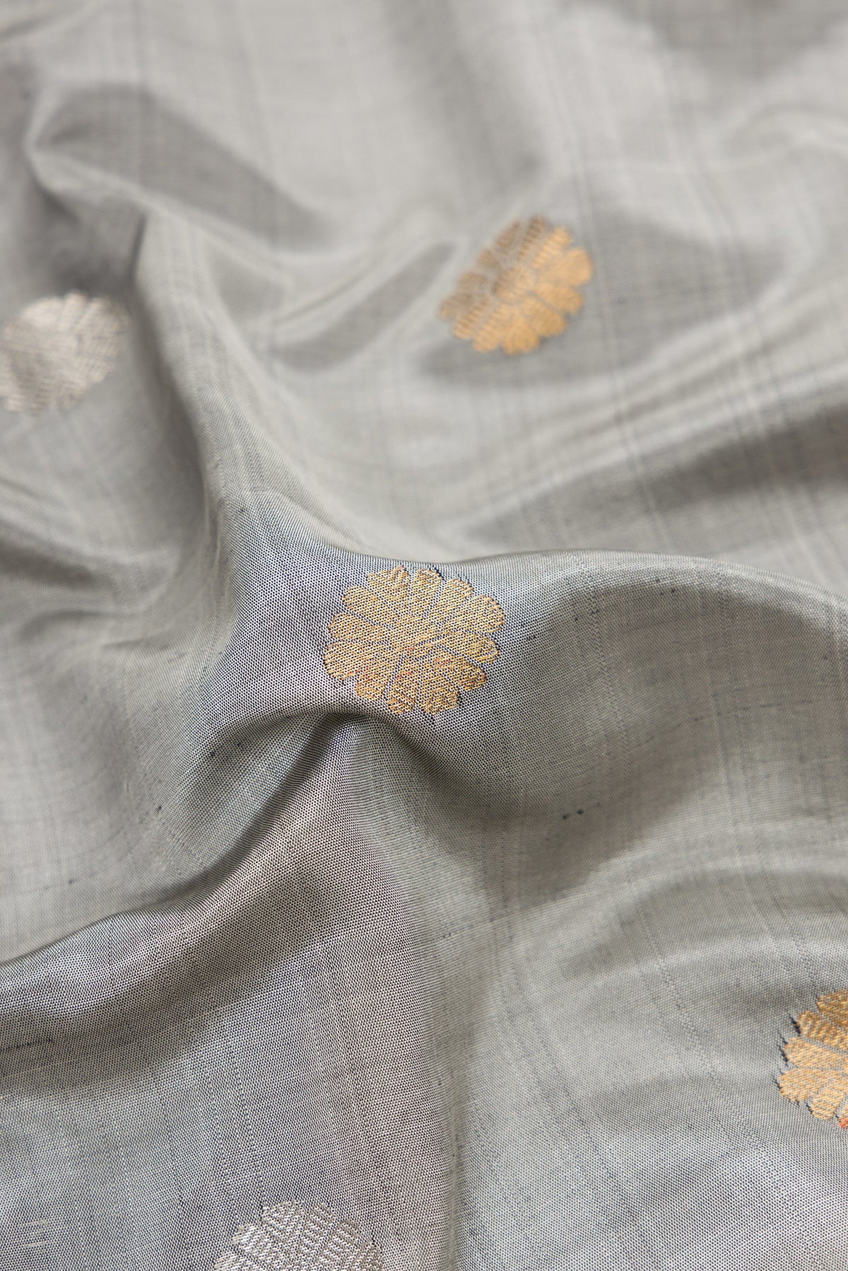 Close up of Grey Dual Tone Gadwal Silk Saree with Zari Butta on the body and Zari Border.  displaying folds
