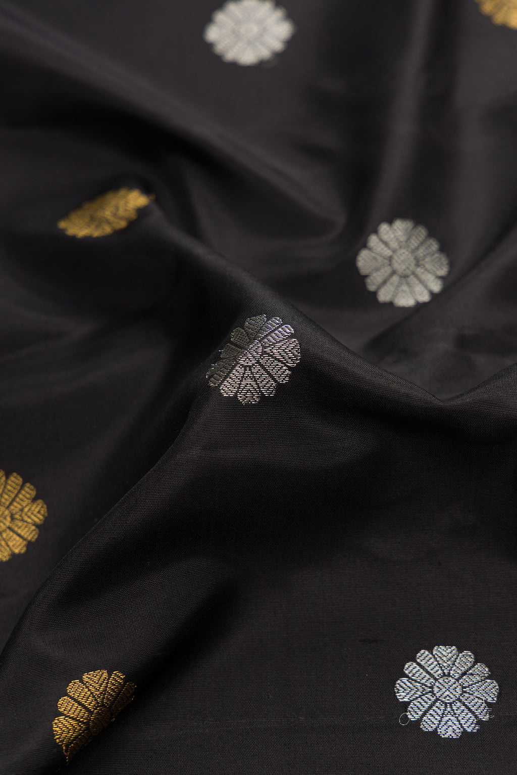 Close up of Black Dual Tone Gadwal Silk Saree with Zari Butta on the body and Zari Border.  displaying folds