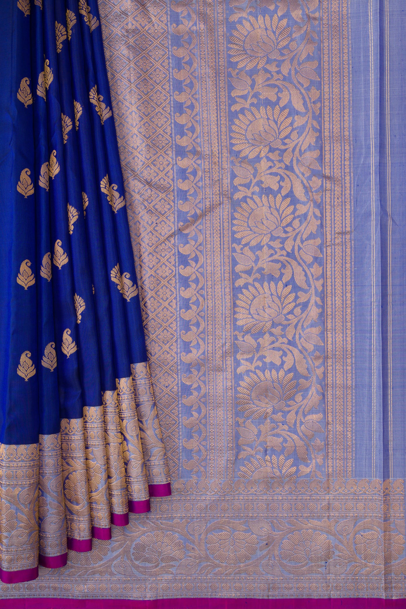 Pleats and pallu of Royal Blue Dual Tone Gadwal Silk Saree with Zari Butta on the body and Zari Border. 