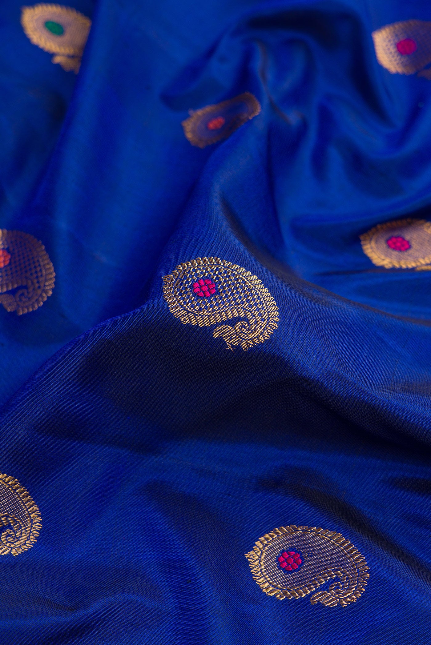 Close up of Royal Blue Dual Tone Gadwal Silk Saree with Zari Butta on the body and Zari Border.  displaying folds