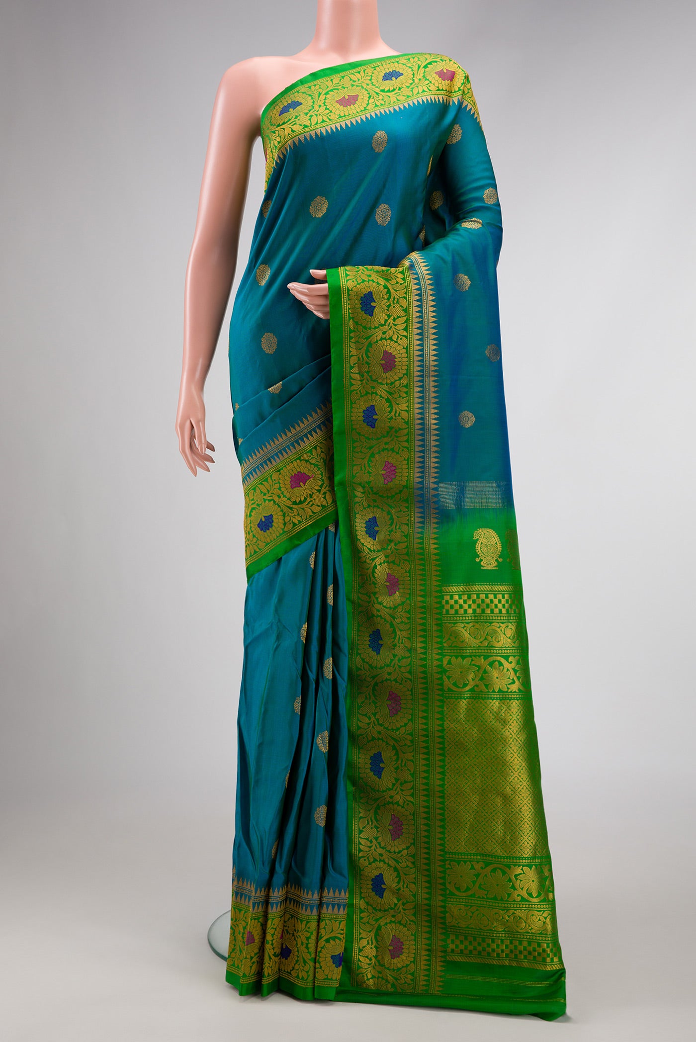 Peacock Blue Dual Tone Gadwal Silk Saree with Zari Butta on the body and Zari Border.  displayed on a mannequin