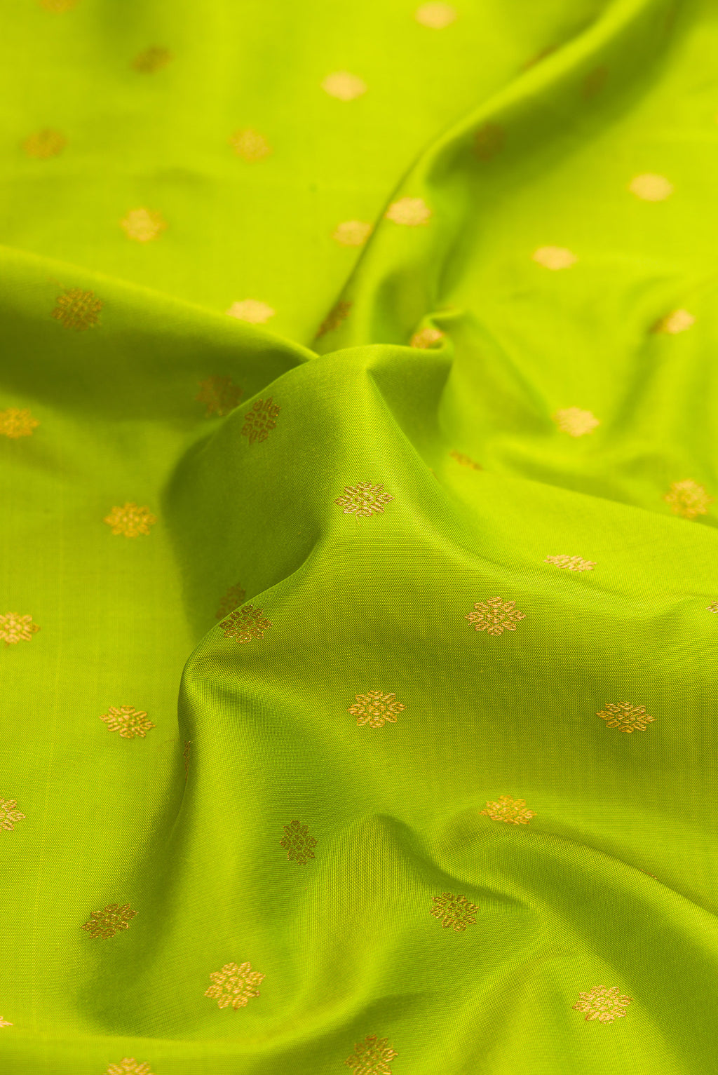 Close up of Parrot Green Dual Tone Paithani Silk Saree with Zari Butta on the body and Zari Border.  displaying folds
