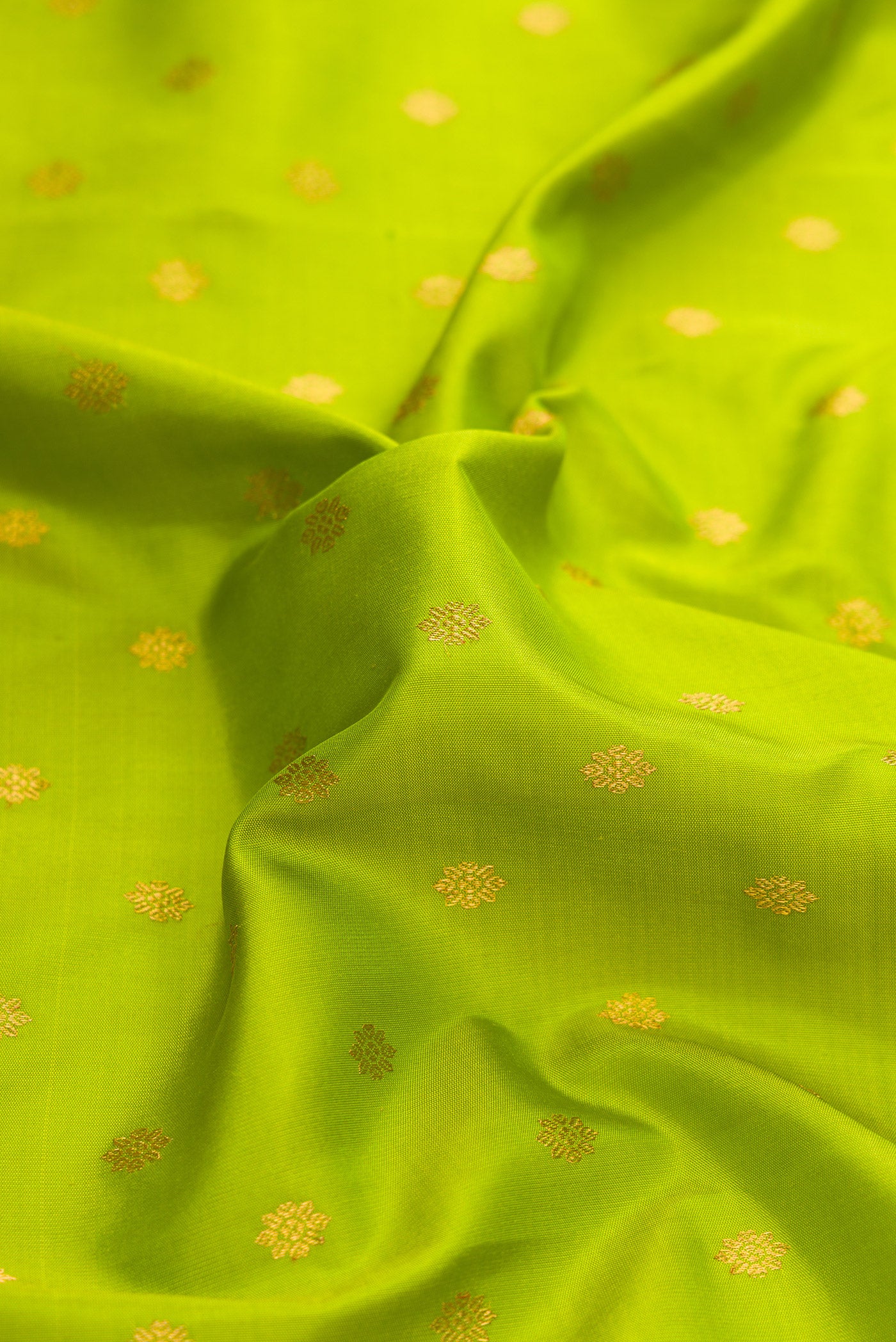 Close up of Parrot Green Dual Tone Paithani Silk Saree with Zari Butta on the body and Zari Border.  displaying folds