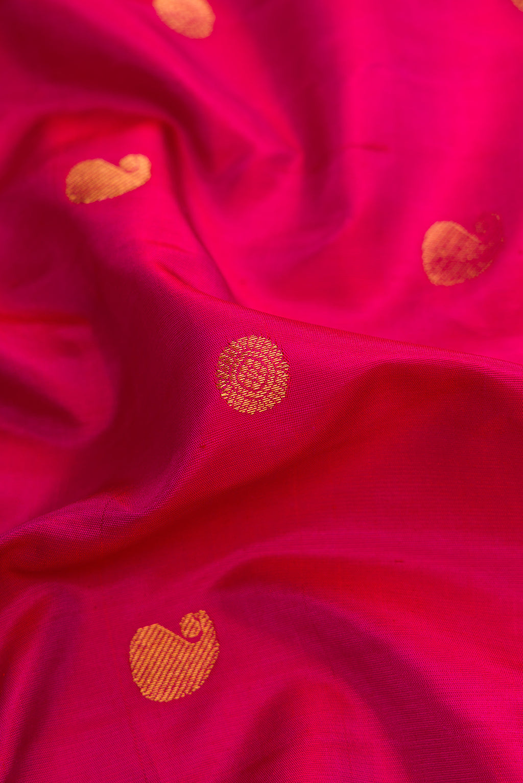 Close up of Pink Dual Tone Paithani Silk Saree with Zari Butta on the body and Zari Border.  displaying folds
