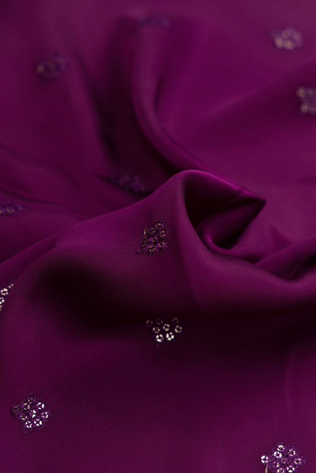 Close up of Purple Dual Tone Crepe Saree with Embroidery on the body and Embroidery Border.  displaying folds