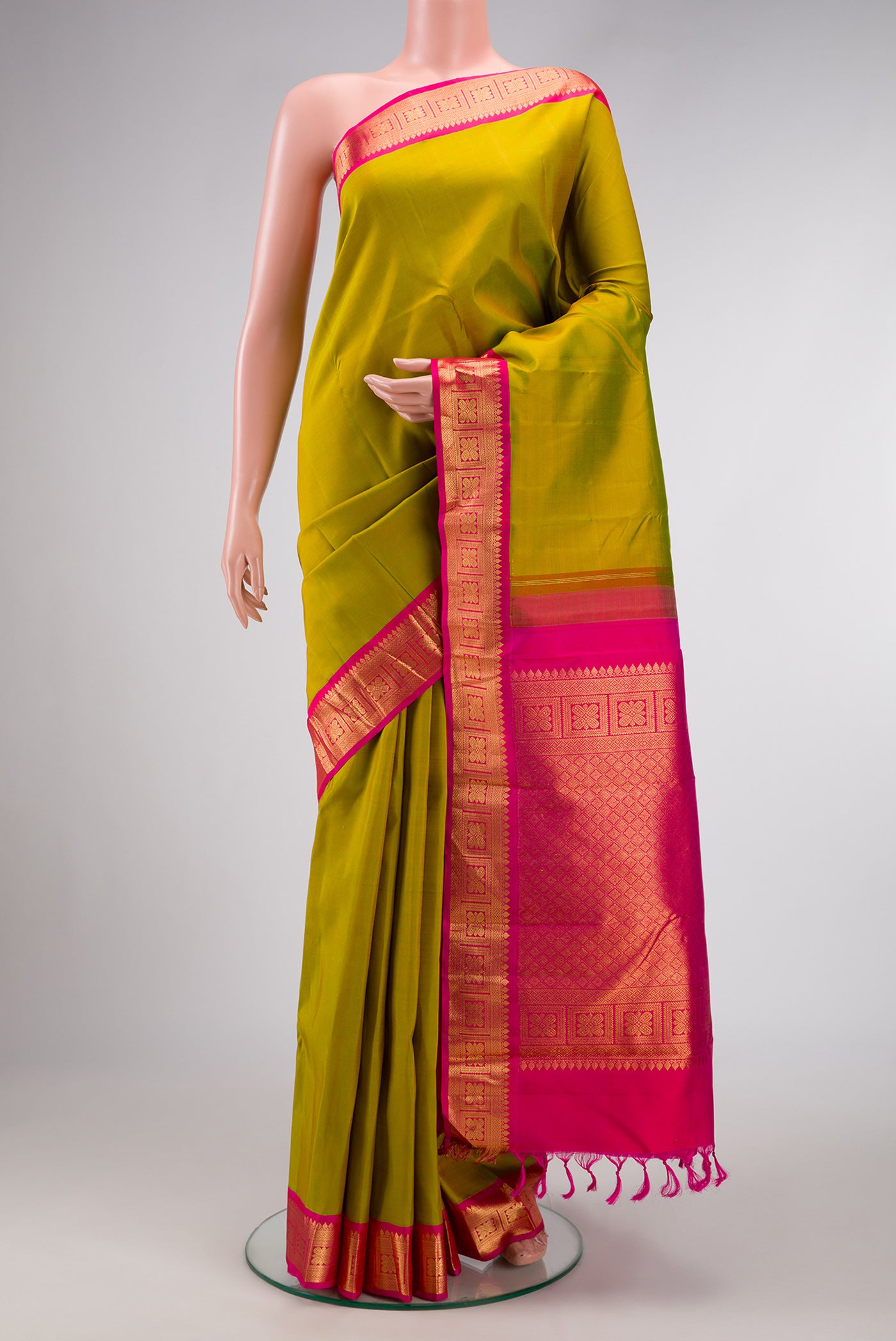 Green Dual Tone Kanjivaram Silk Saree with Plain Body and Zari Border.  displayed on a mannequin