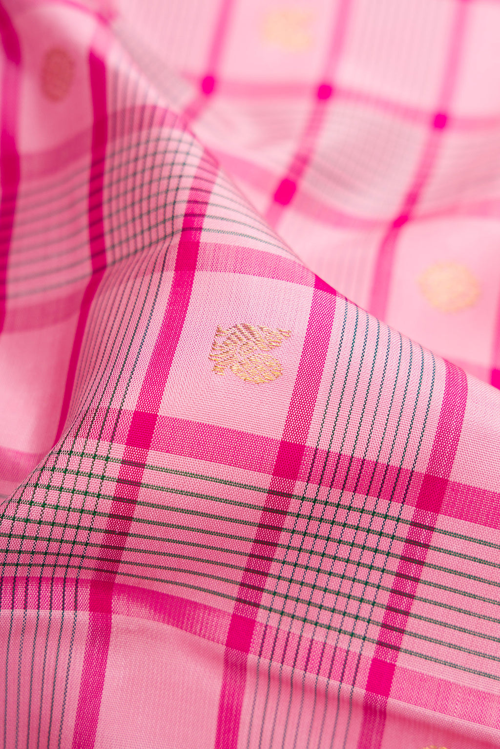 Close up of Pure Silk Pure Zari Pink Dual Tone Kanjivaram Saree with Checked design on the body and Zari Border.  displaying folds