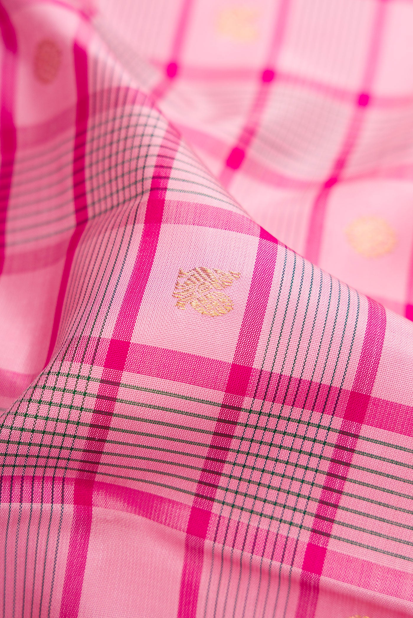 Close up of Pure Silk Pure Zari Pink Dual Tone Kanjivaram Saree with Checked design on the body and Zari Border.  displaying folds