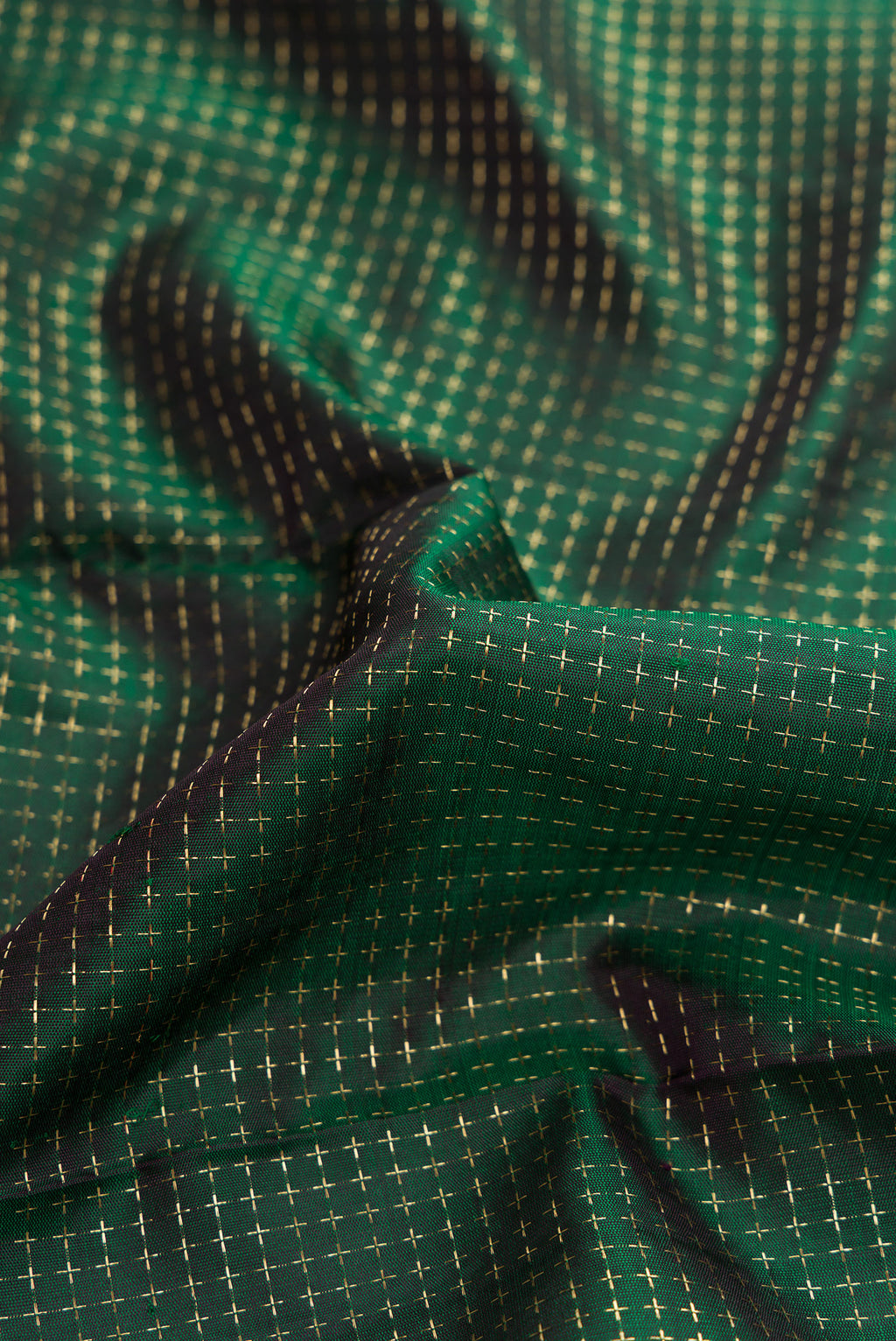 Close up of Bottle Green Dual Tone Kanjivaram Silk Saree with Checked design on the body and Zari Border.  displaying folds