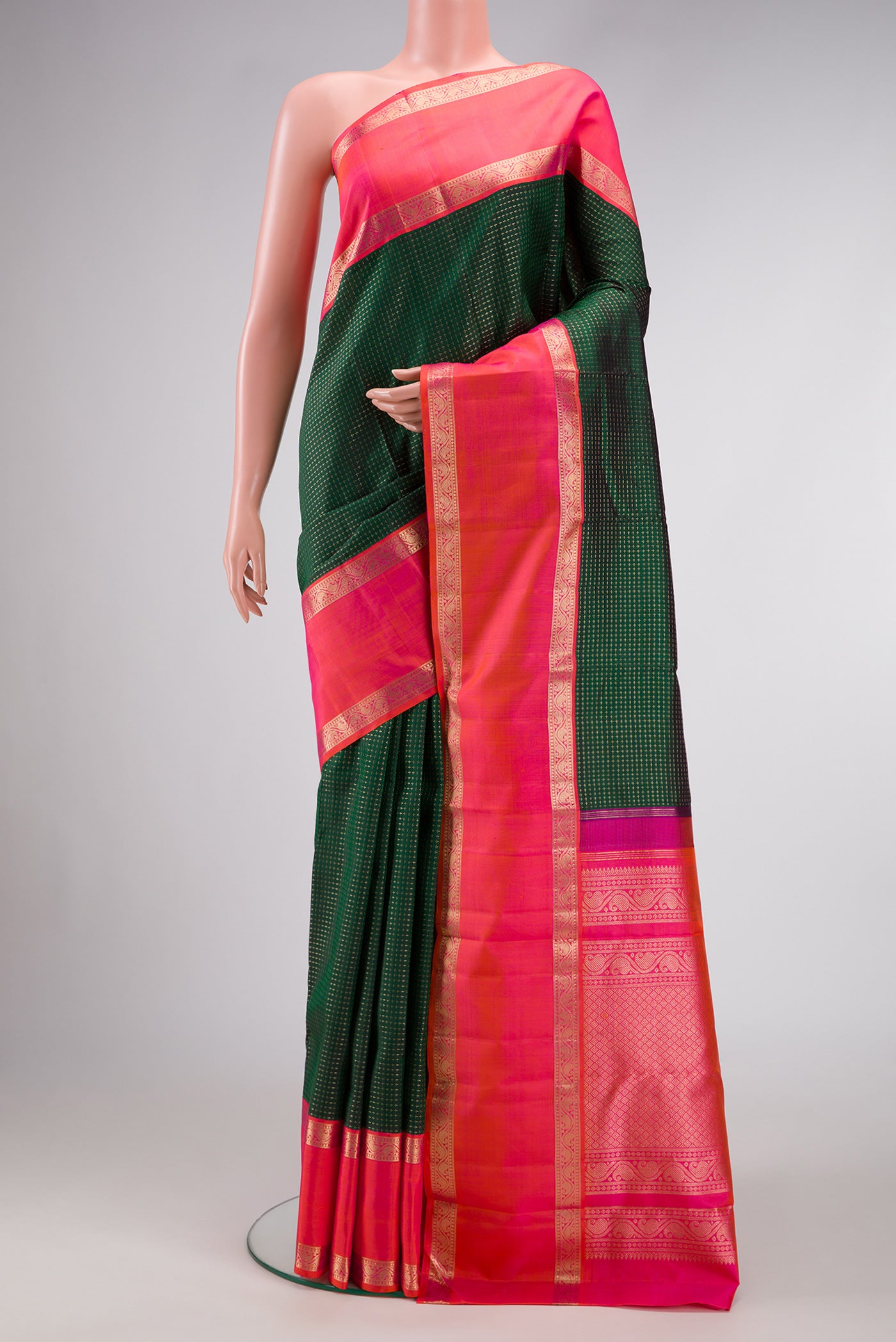 Bottle Green Dual Tone Kanjivaram Silk Saree with Checked design on the body and Zari Border.  displayed on a mannequin