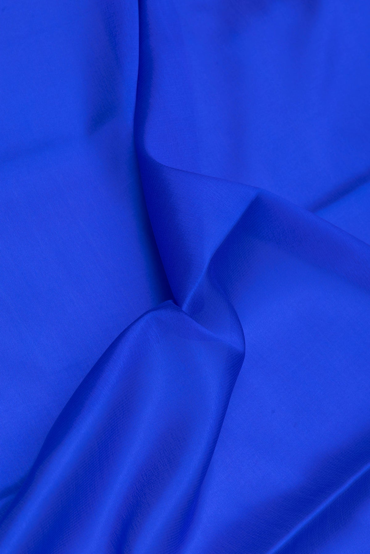 Close up of Royal Blue Mysore Silk Saree with Plain Body and Zari Border.  displaying folds