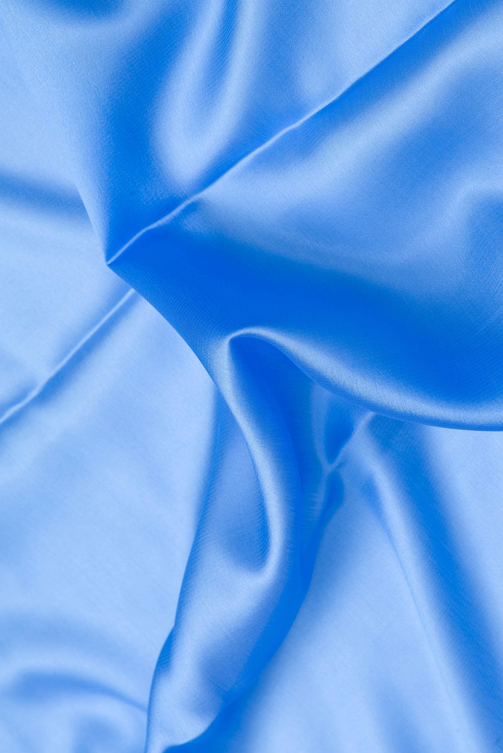 Close up of Light Blue Dual Tone Mysore Crepe Saree with Plain Body and Zari Border.  displaying folds
