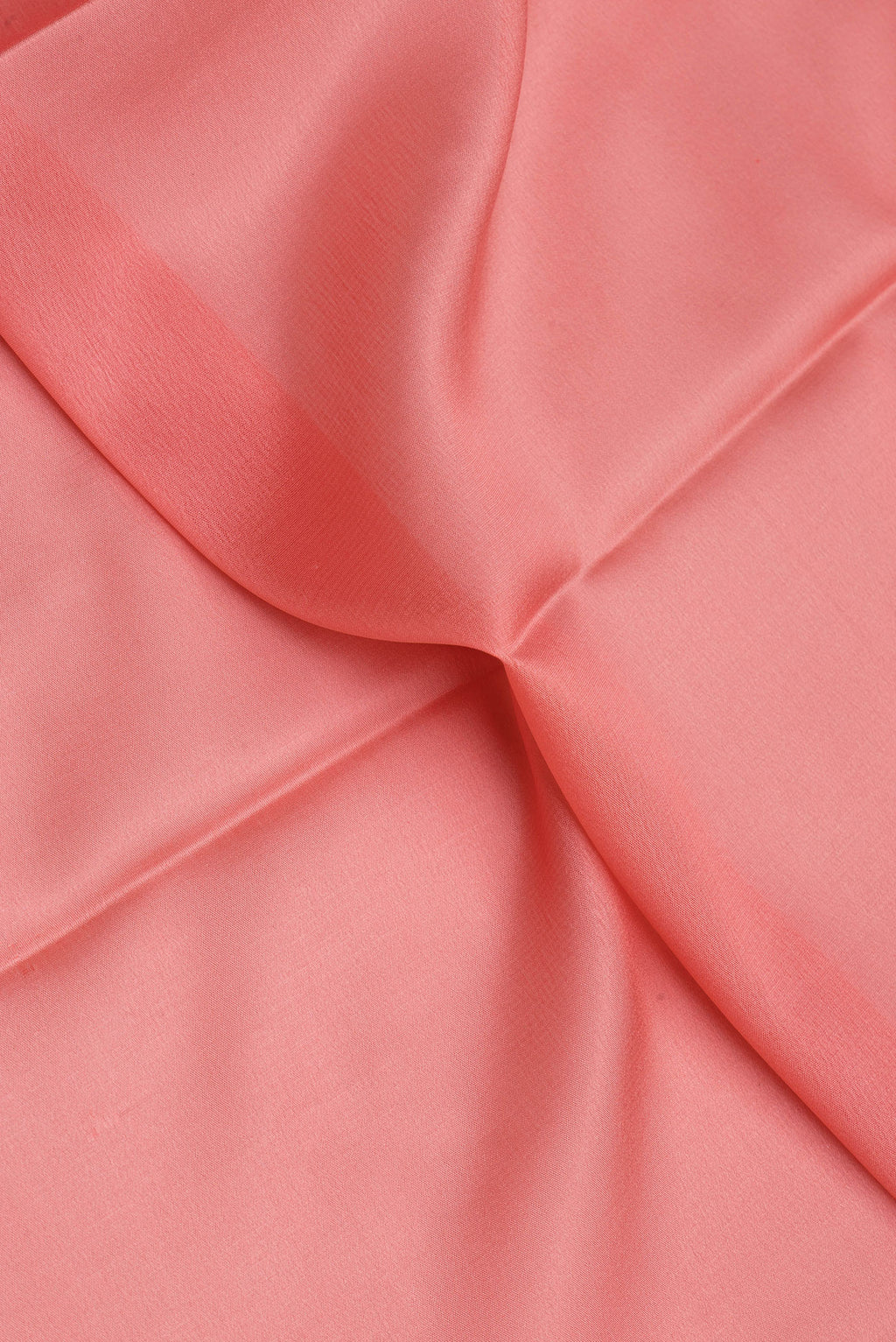Close up of Peach Mysore Crepe Saree with Plain Body and Zari Border.  displaying folds
