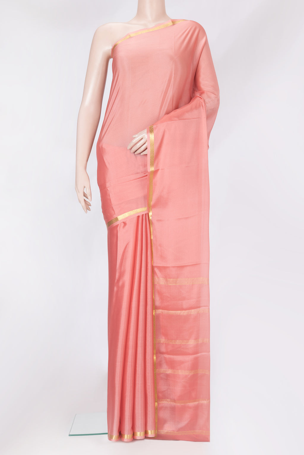 Peach Mysore Crepe Saree with Plain Body and Zari Border.  displayed on a mannequin