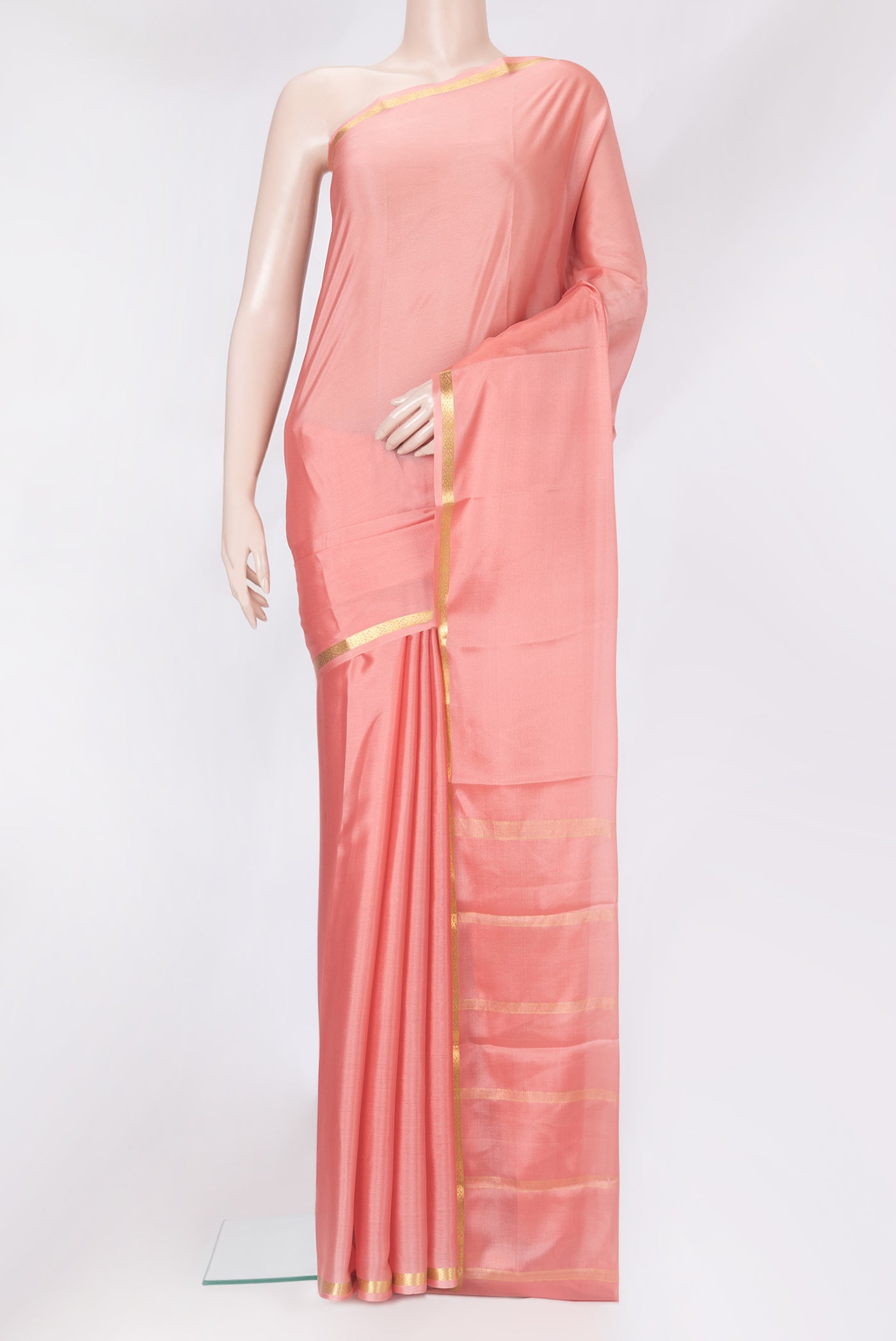 Peach Mysore Crepe Saree with Plain Body and Zari Border.  displayed on a mannequin