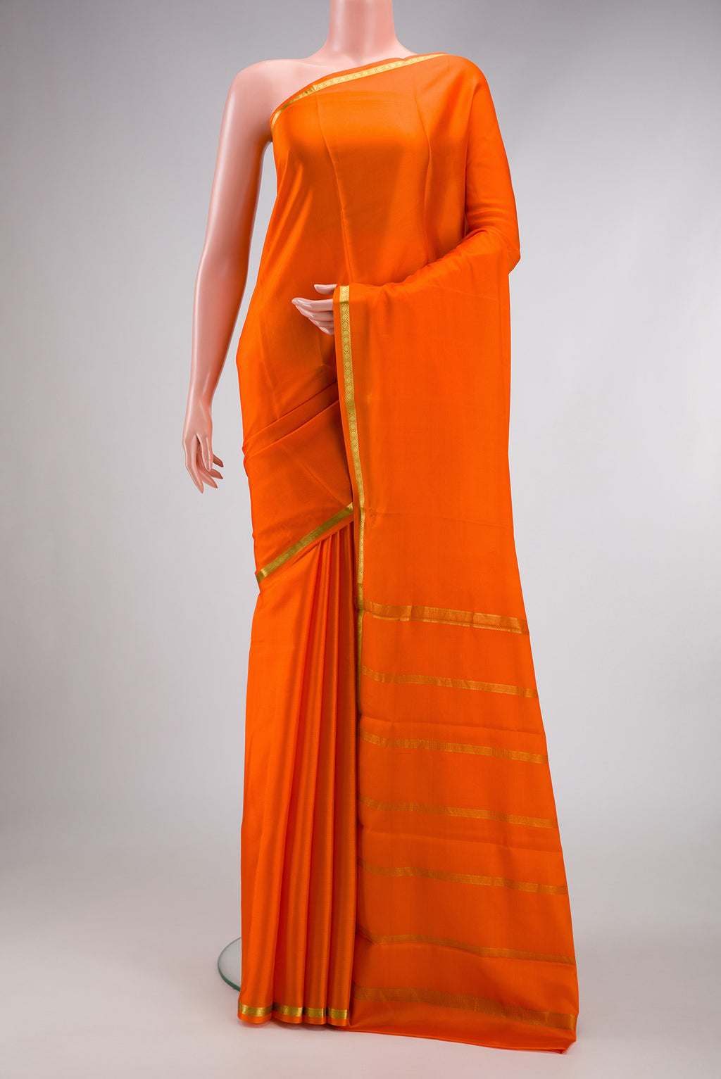 Orange Mysore Crepe Saree with Plain Body and Zari Border.  displayed on a mannequin
