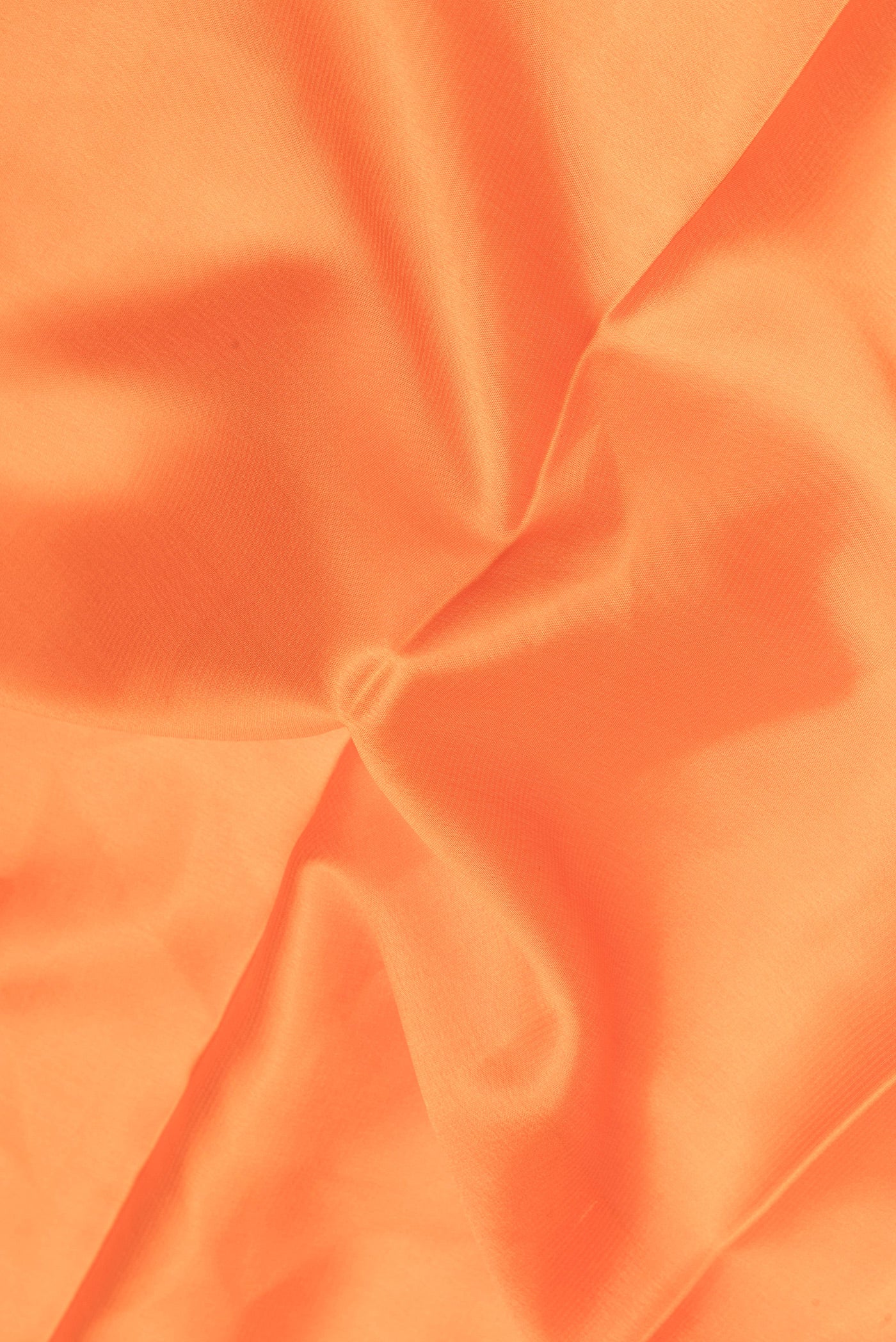 Close up of Orange Mysore Crepe Saree with Plain Body and Zari Border.  displaying folds