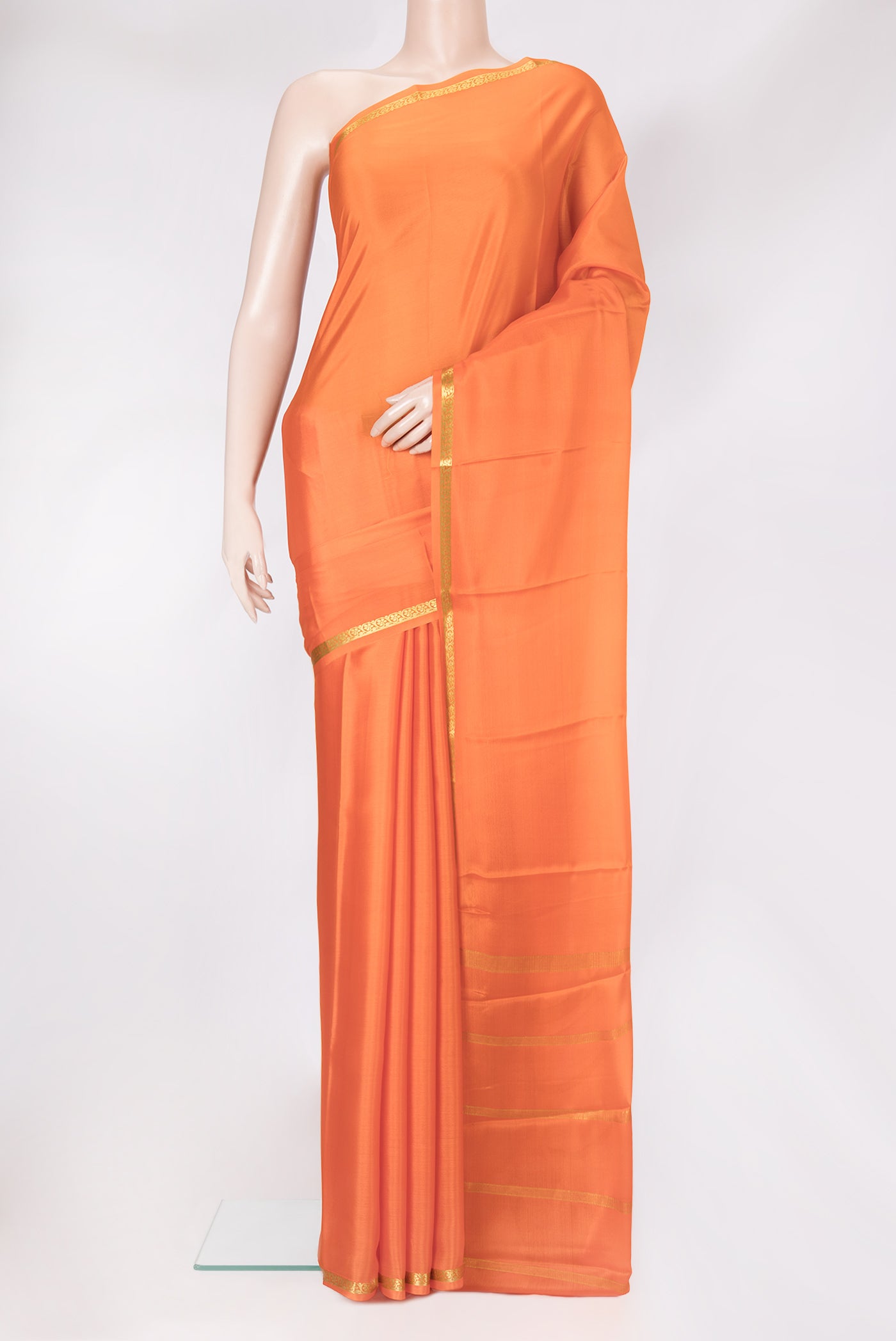 Orange Mysore Crepe Saree with Plain Body and Zari Border.  displayed on a mannequin