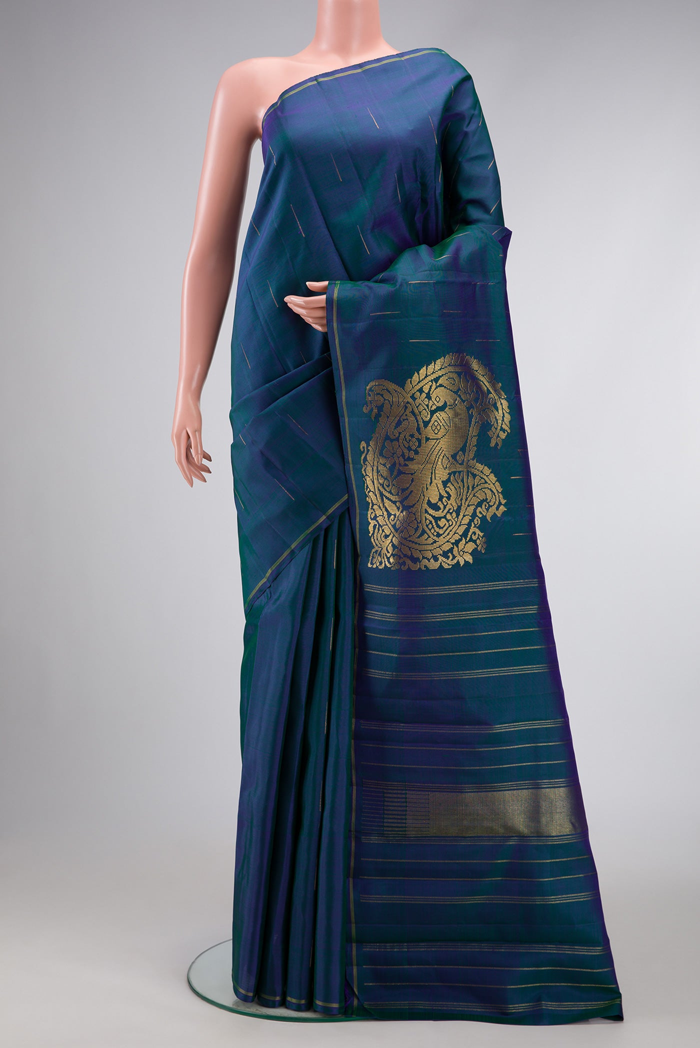 Peacock Blue Dual Tone Kanjivaram Silk Saree with Zari Butta on the body and Thin Zari Line.  displayed on a mannequin