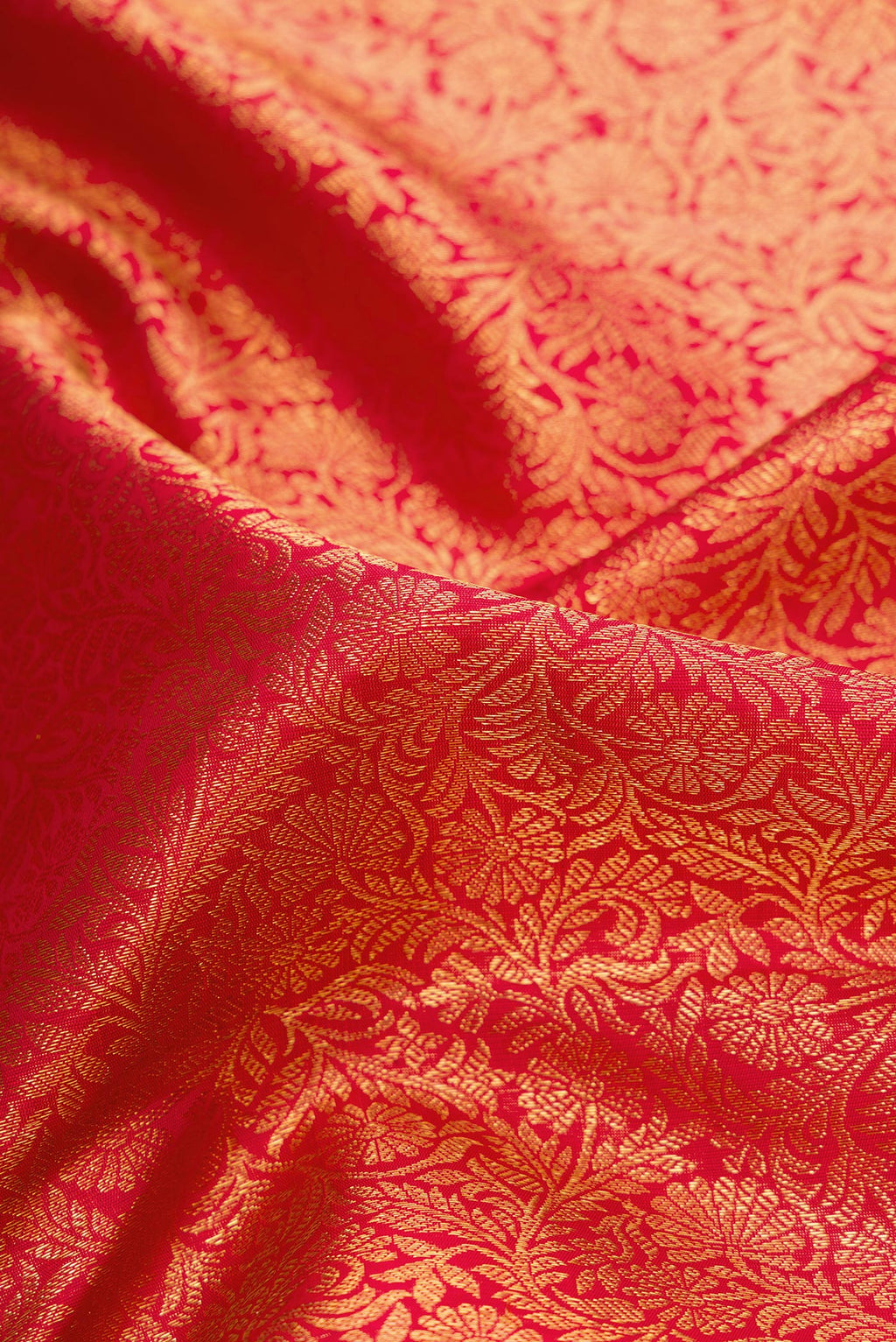 Close up of Dark Pink Dual Tone Kanchipuram Silk Saree with Zari Brocade on the body and Zari Border.  displaying folds