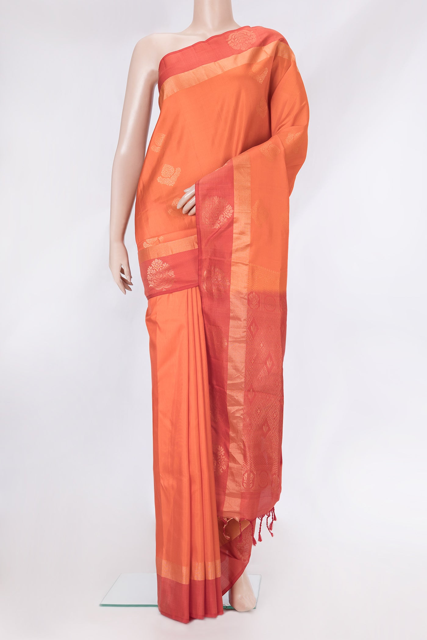Golden Peach Dual Tone Soft Silk Saree with Zari Butta on the body and Fancy Border.  displayed on a mannequin