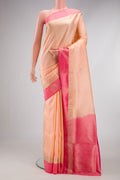 Peach Soft Silk Saree with Zari Butta on the body and Fancy Border.  displayed on a mannequin